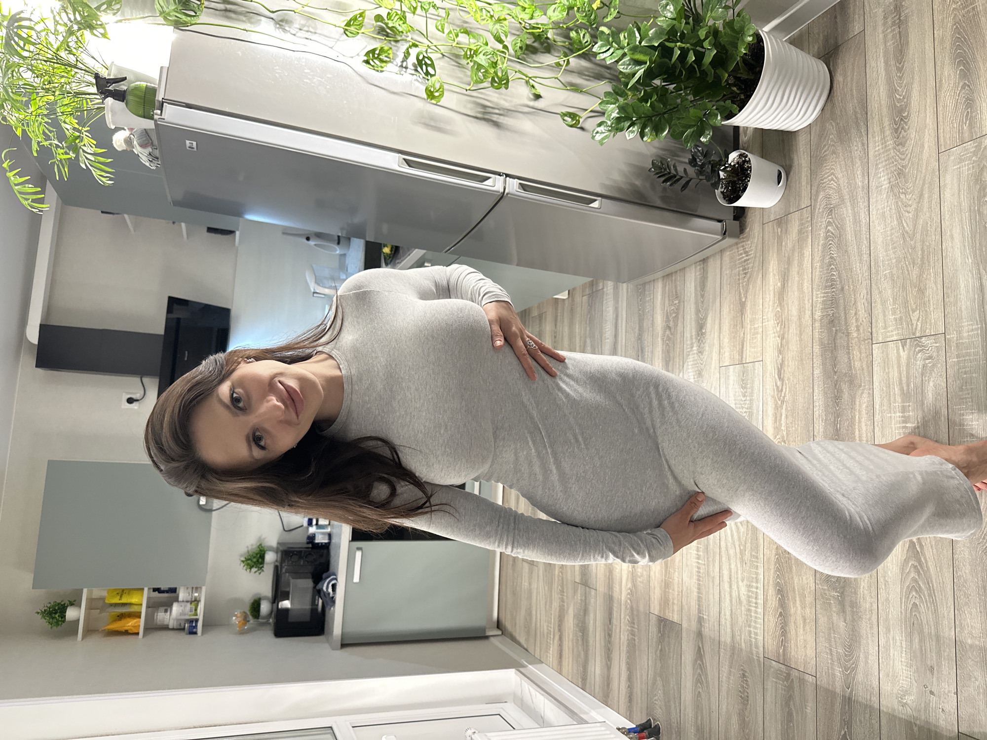 Pregnant woman cooks with air fryer in Russian kitchen