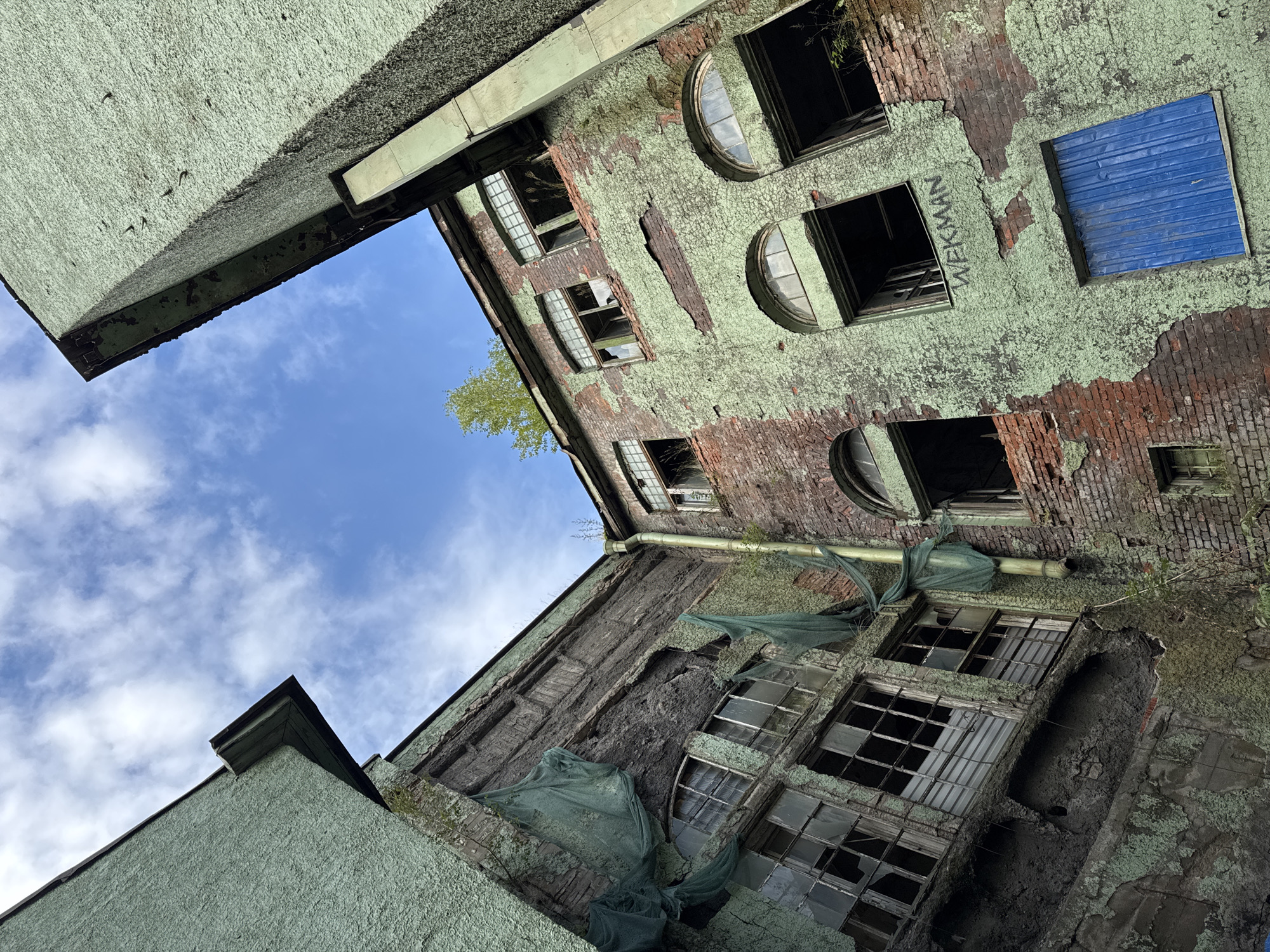Peeling paint and exposed brick on a Novosaratovka apartment block