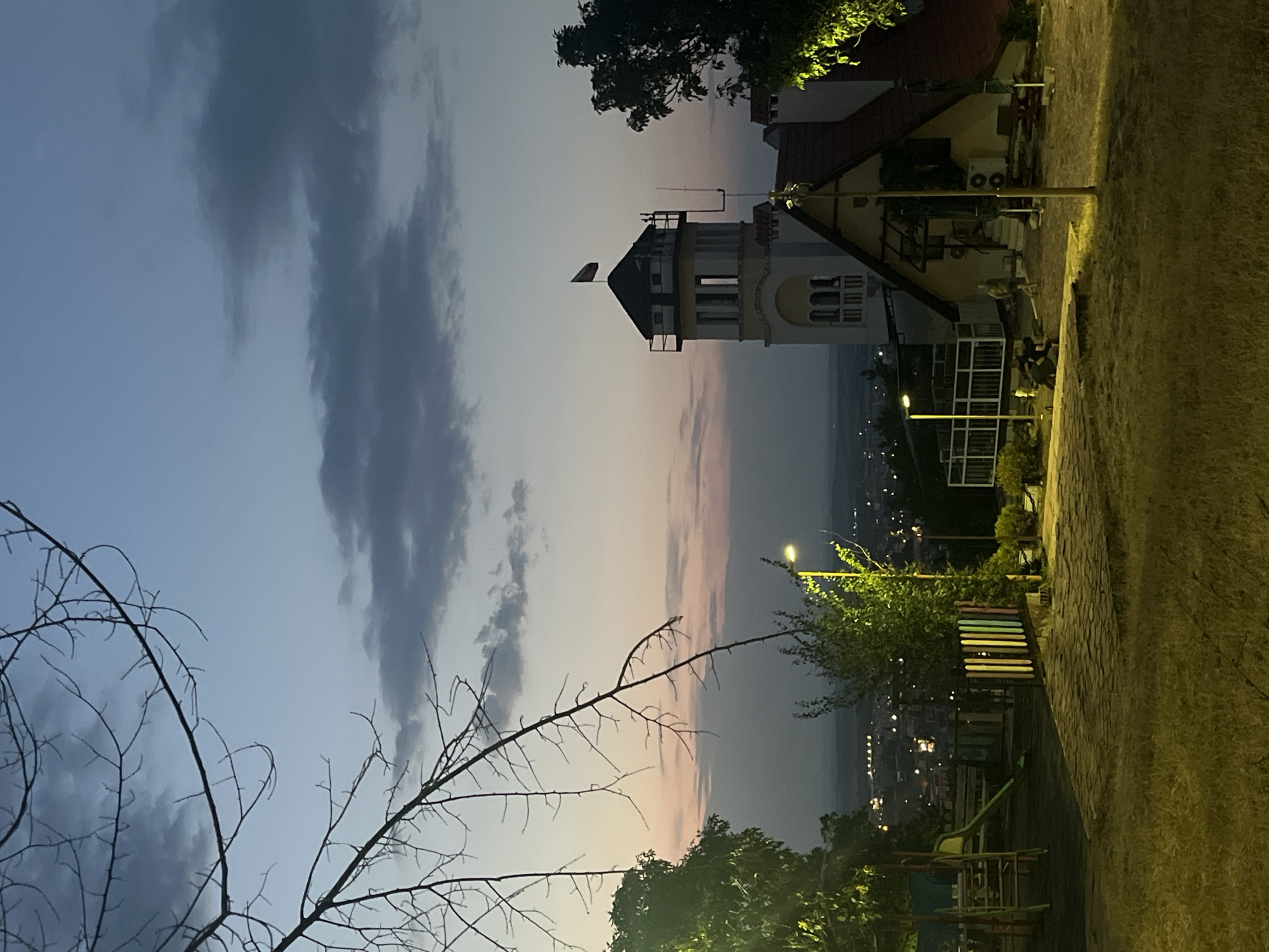 Dusk settles over a Vratsa public square and its landmark tower