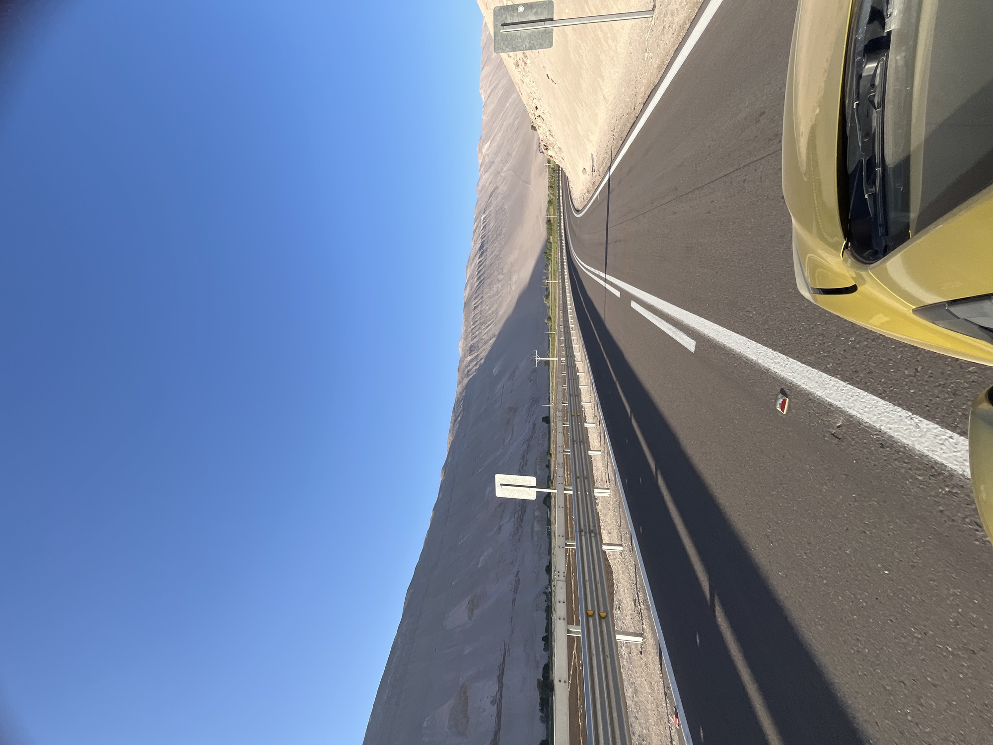 Driver travels highway in Arica, Chile under clear skies
