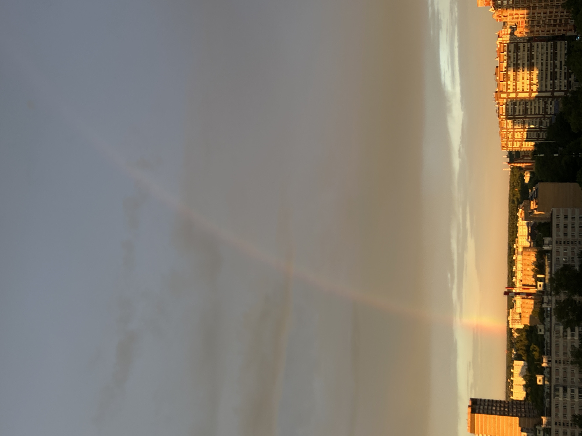 Rainbow over Dolgoprudny rooftops at golden hour