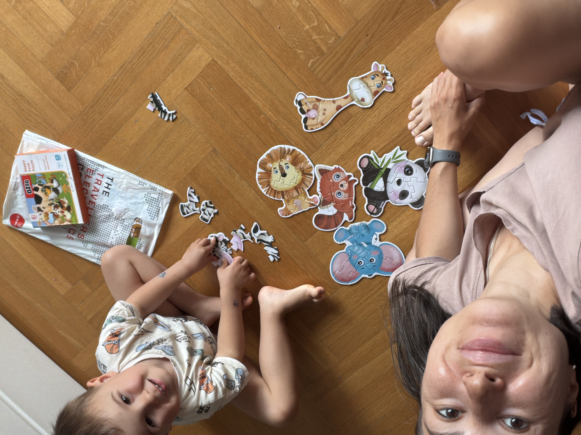 Mother and child work on animal puzzle in Budva