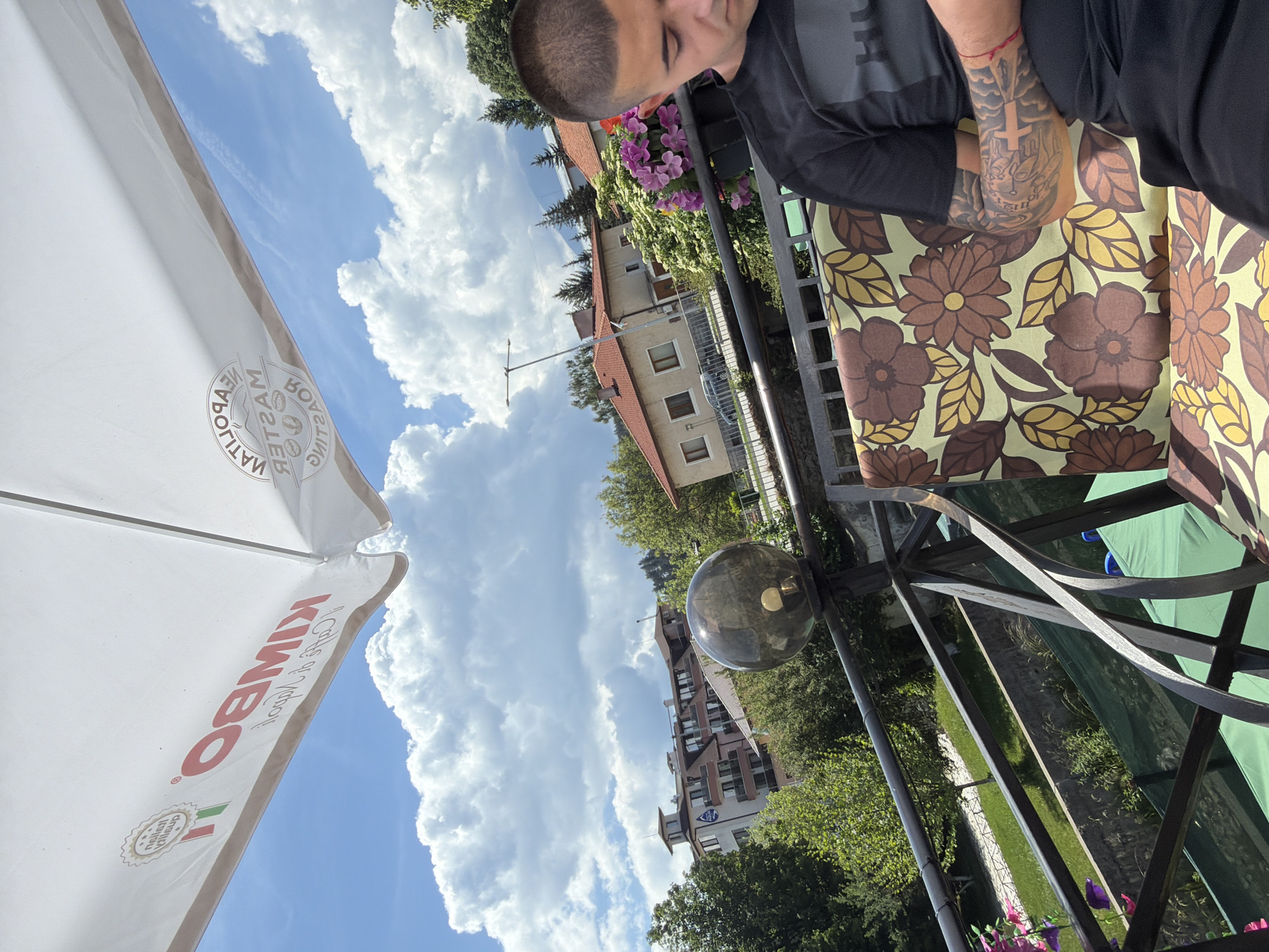 Young Man Photographed at Outdoor Cafe in Paris Setting