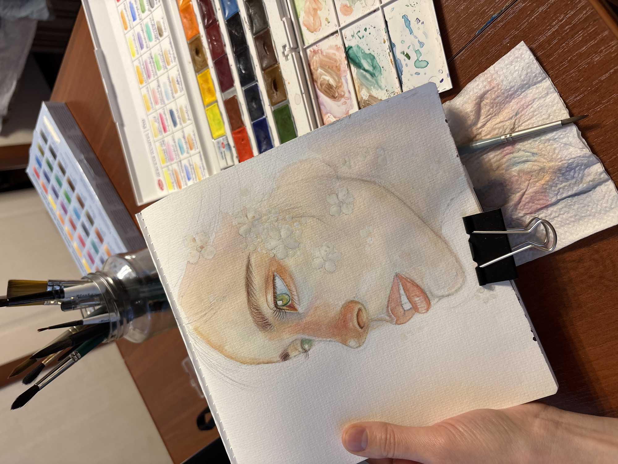 Artist creates watercolor portrait with floral details in Izhevsk