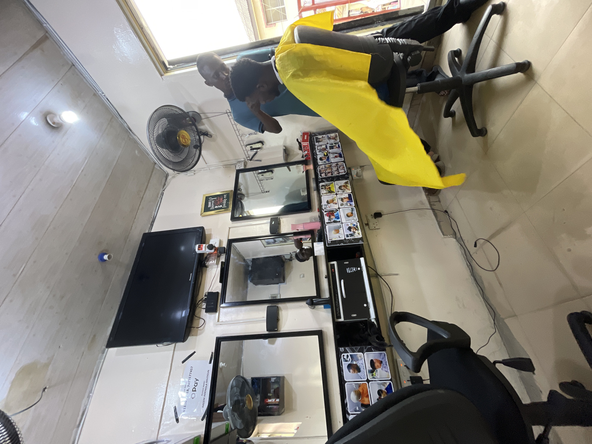 Haircut session documented at barbershop in Ado, Nigeria