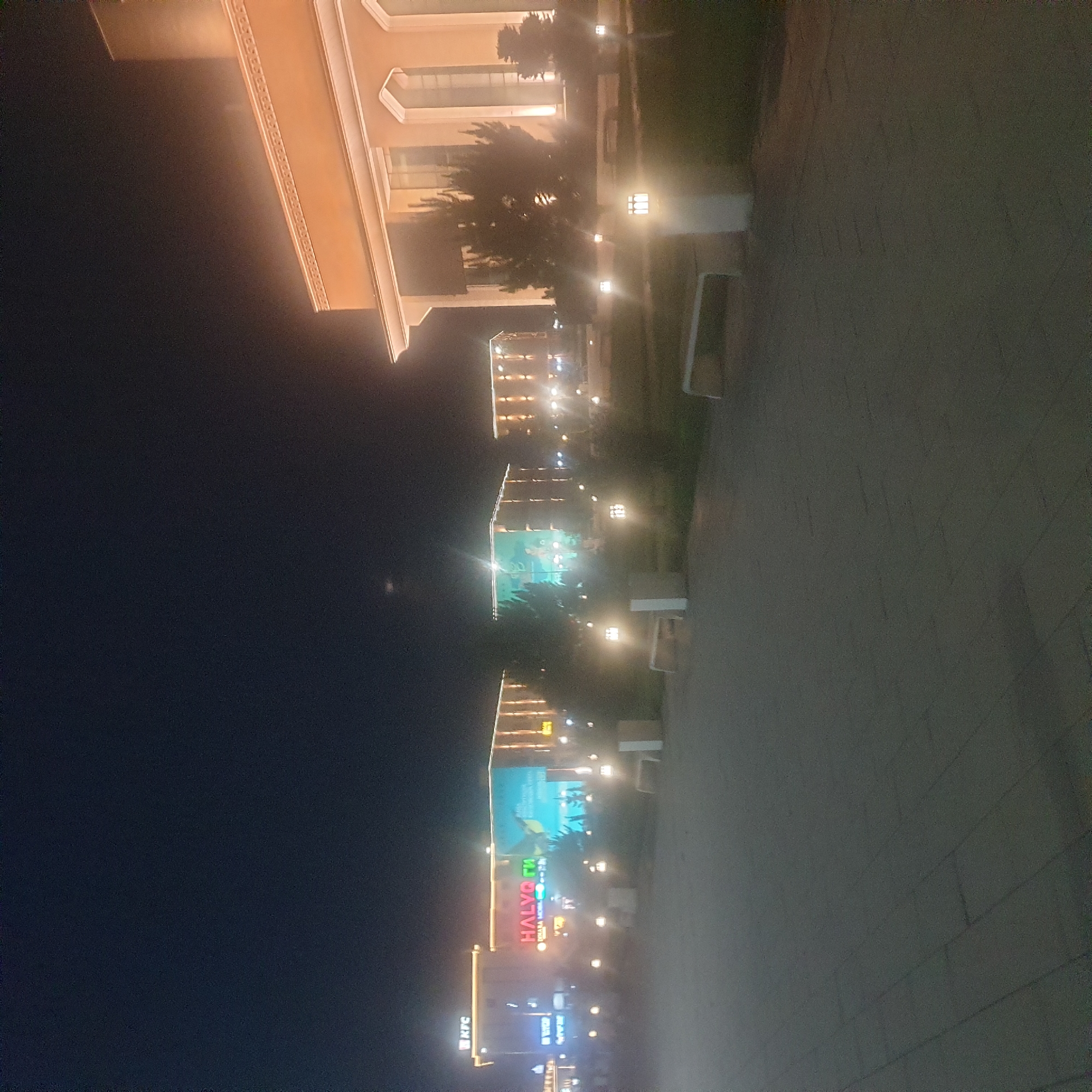Nighttime stroll documented through illuminated Turkistan, Kazakhstan city center