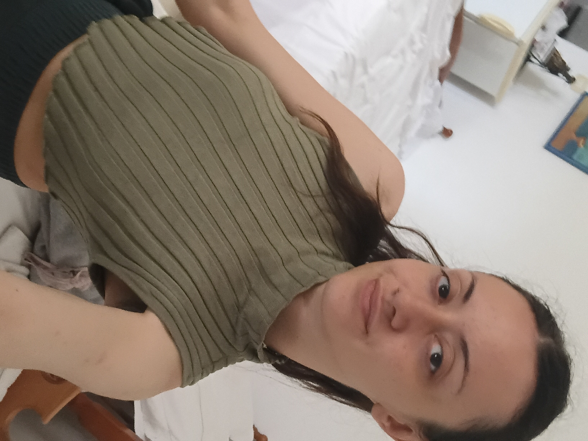 Woman takes selfies in green top in Vlora, Albania