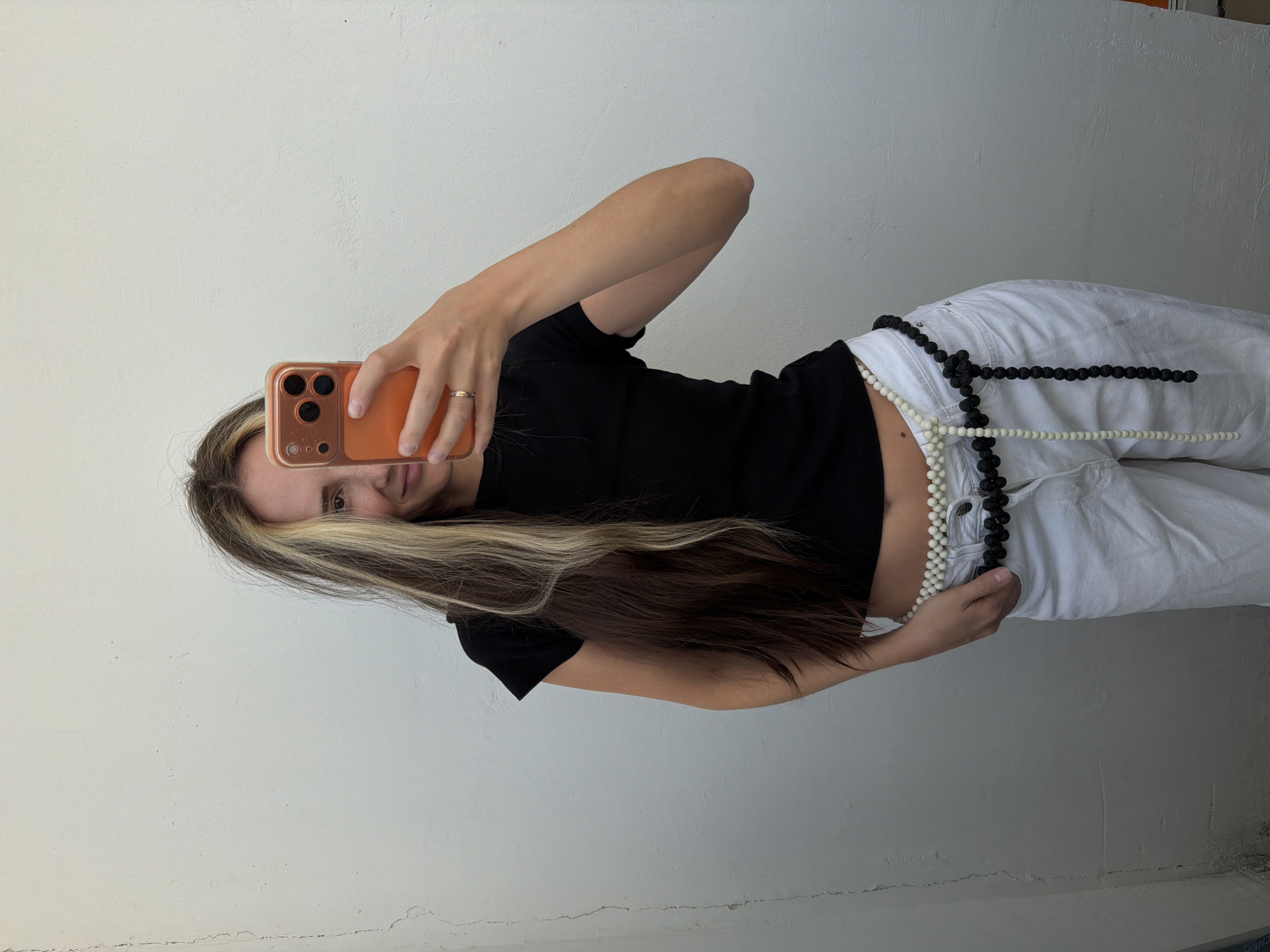 Woman takes selfies against wall in Khimki, Russia