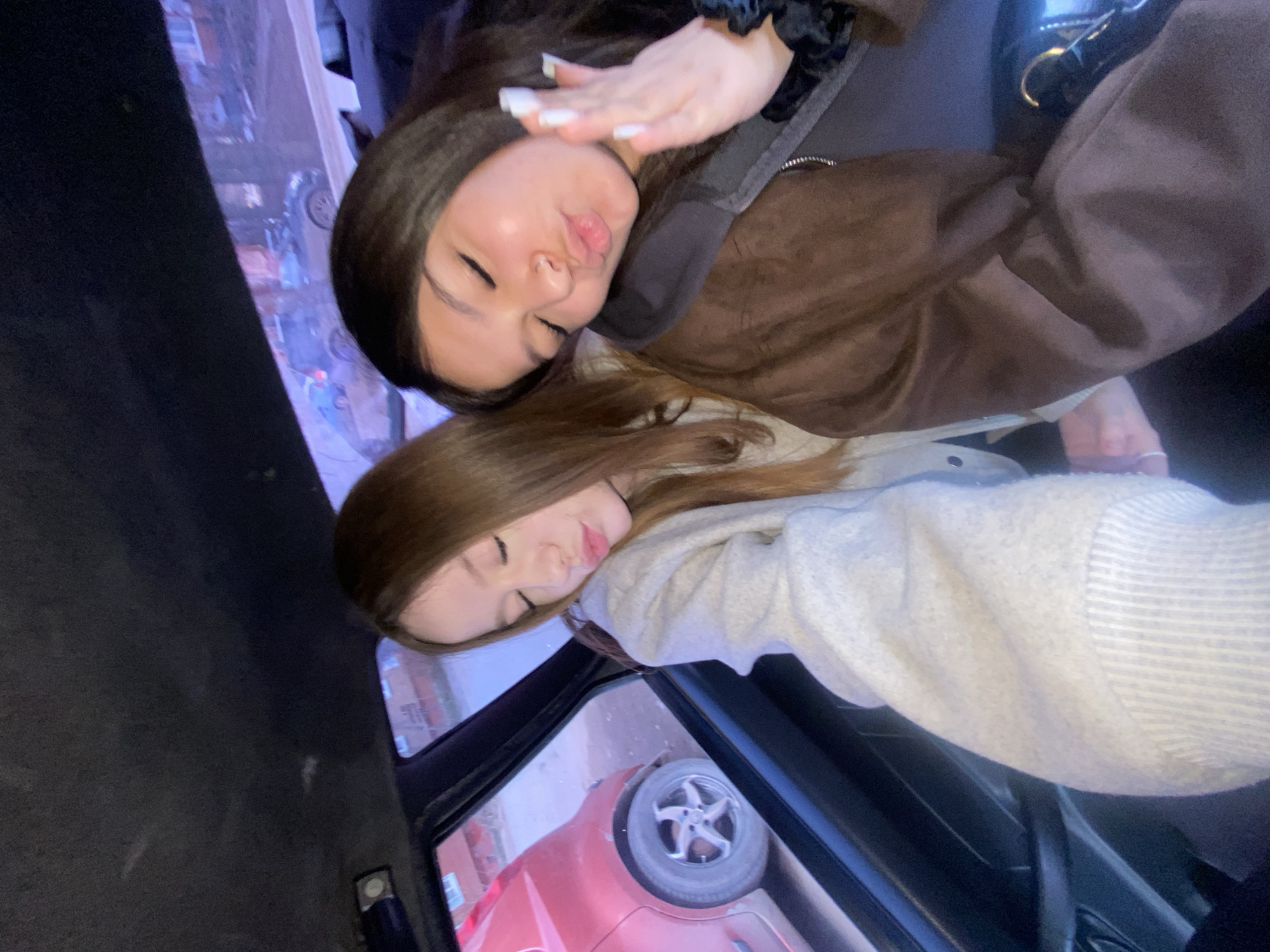 Two women take playful selfies in taxi in Votkinsk