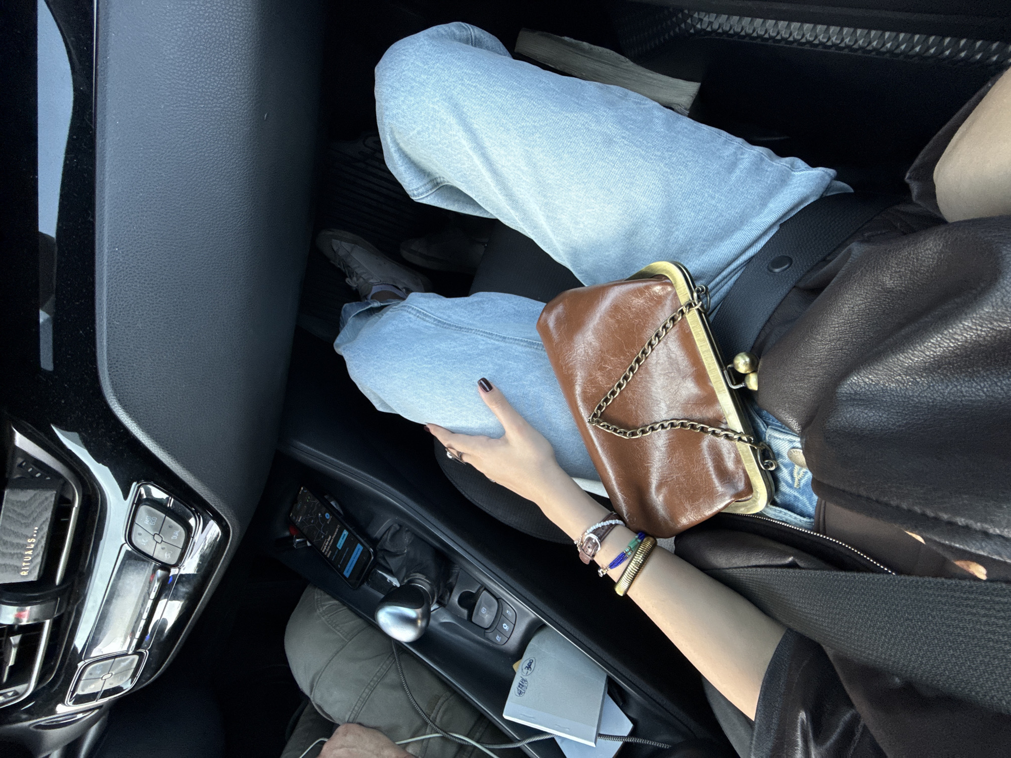 Person photographed from car interior on Milan street