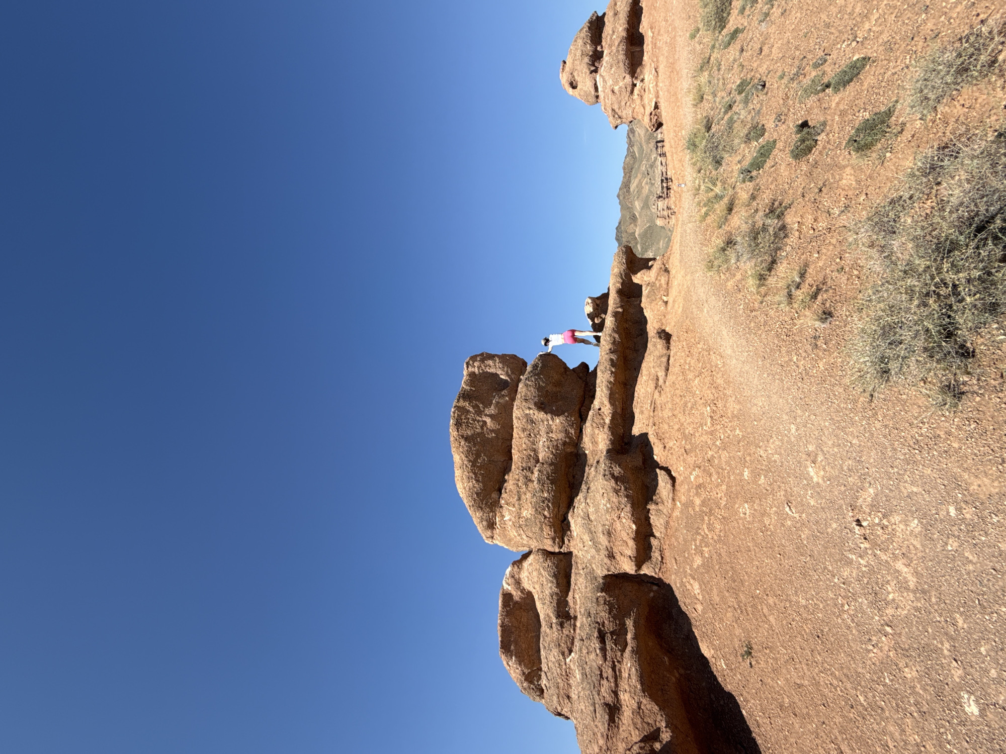Pausing on a red rock ledge in Kazakhstan's canyon country