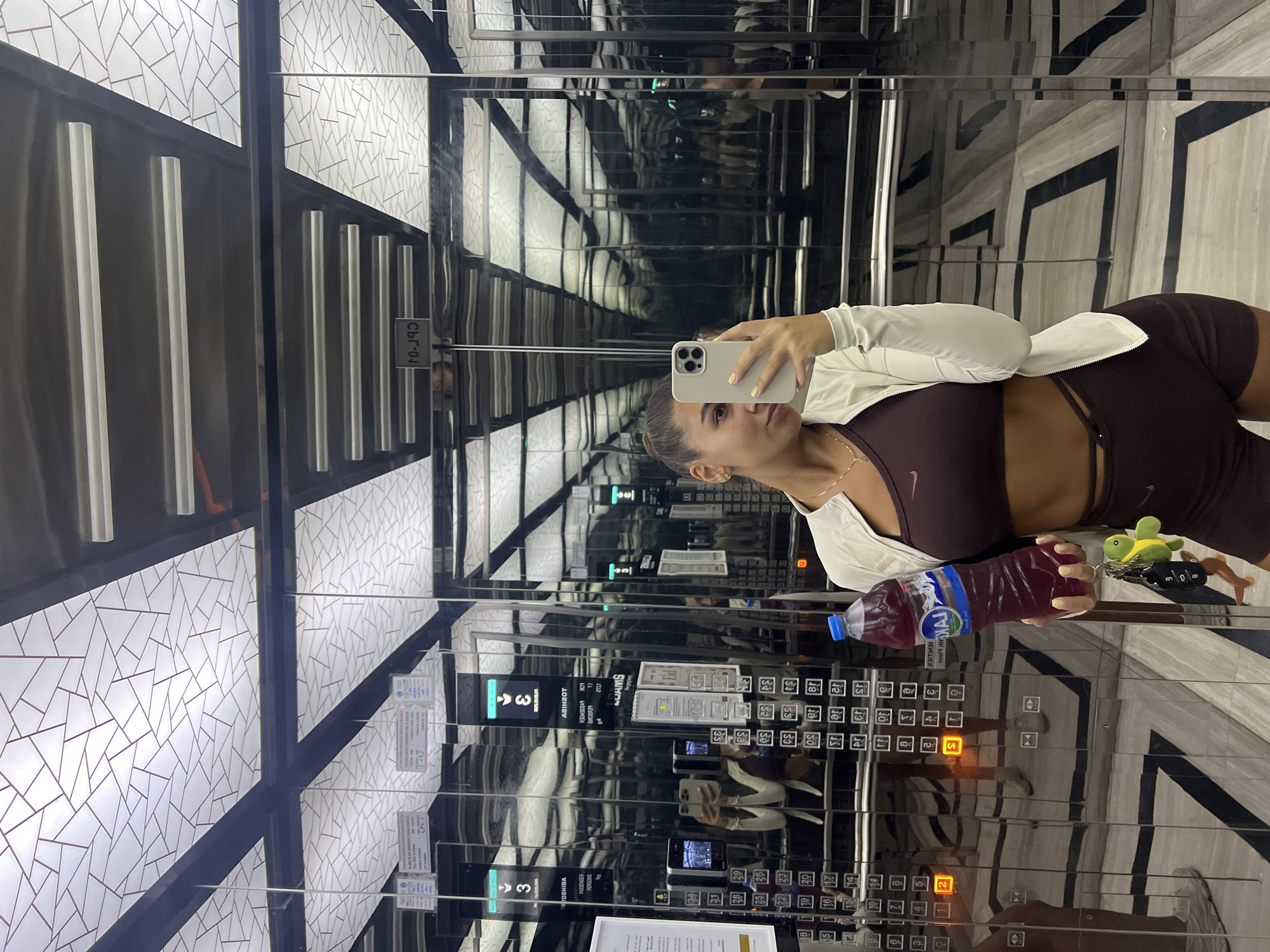 Woman takes selfie in mirrored elevator in Dubai