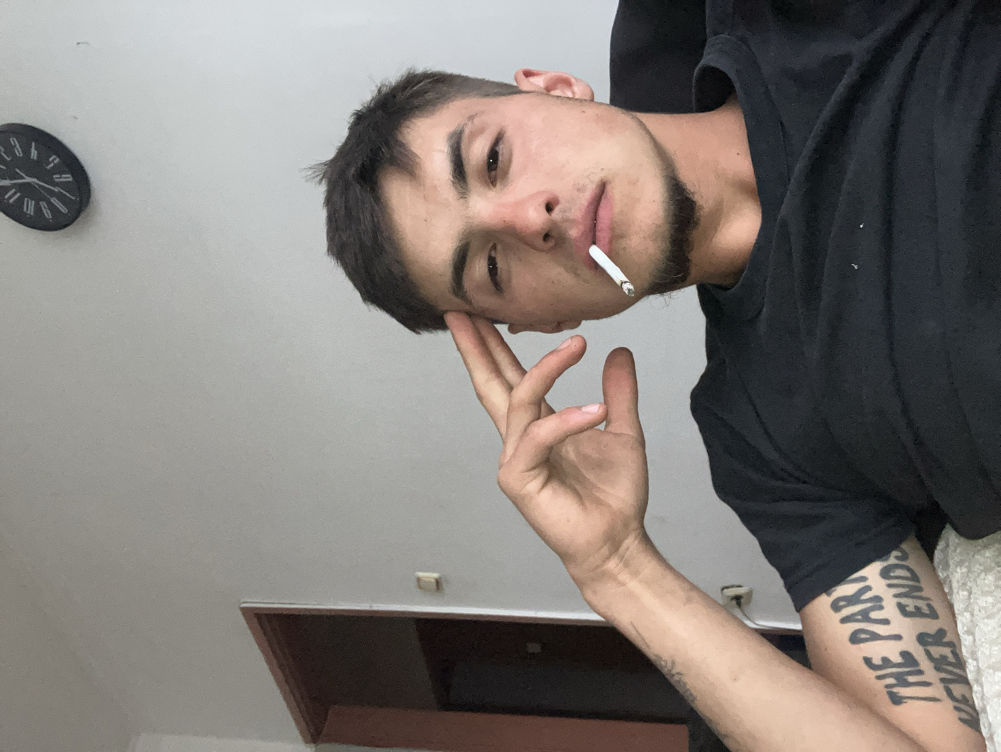 Young man photographs himself smoking, posing in Plovdiv bathroom