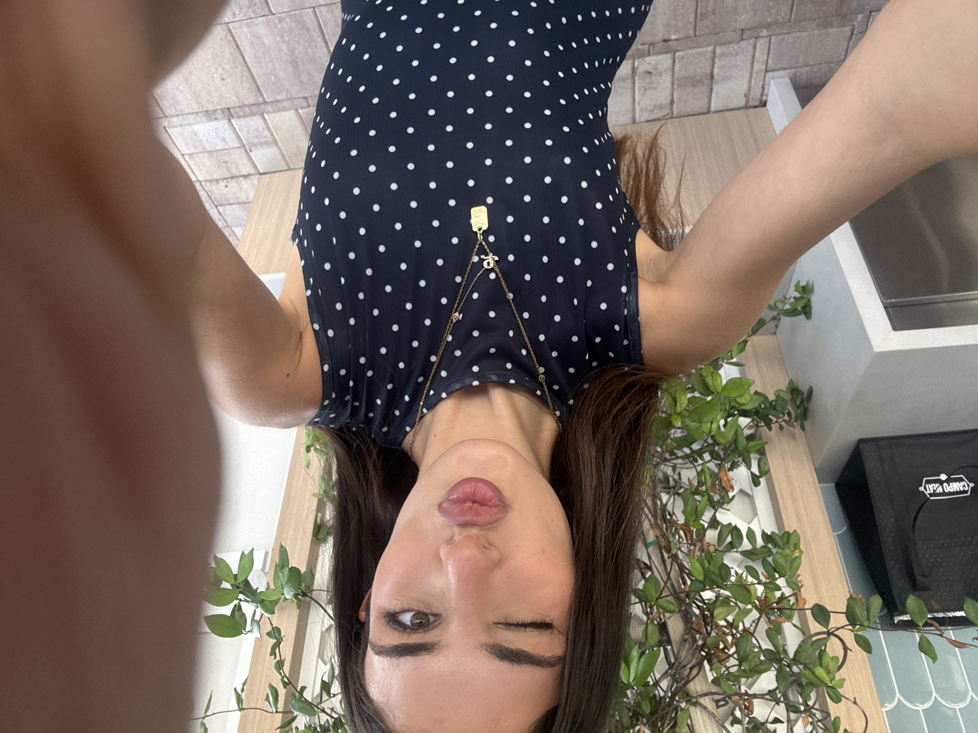 Outdoor patio photo session in a navy polka dot dress