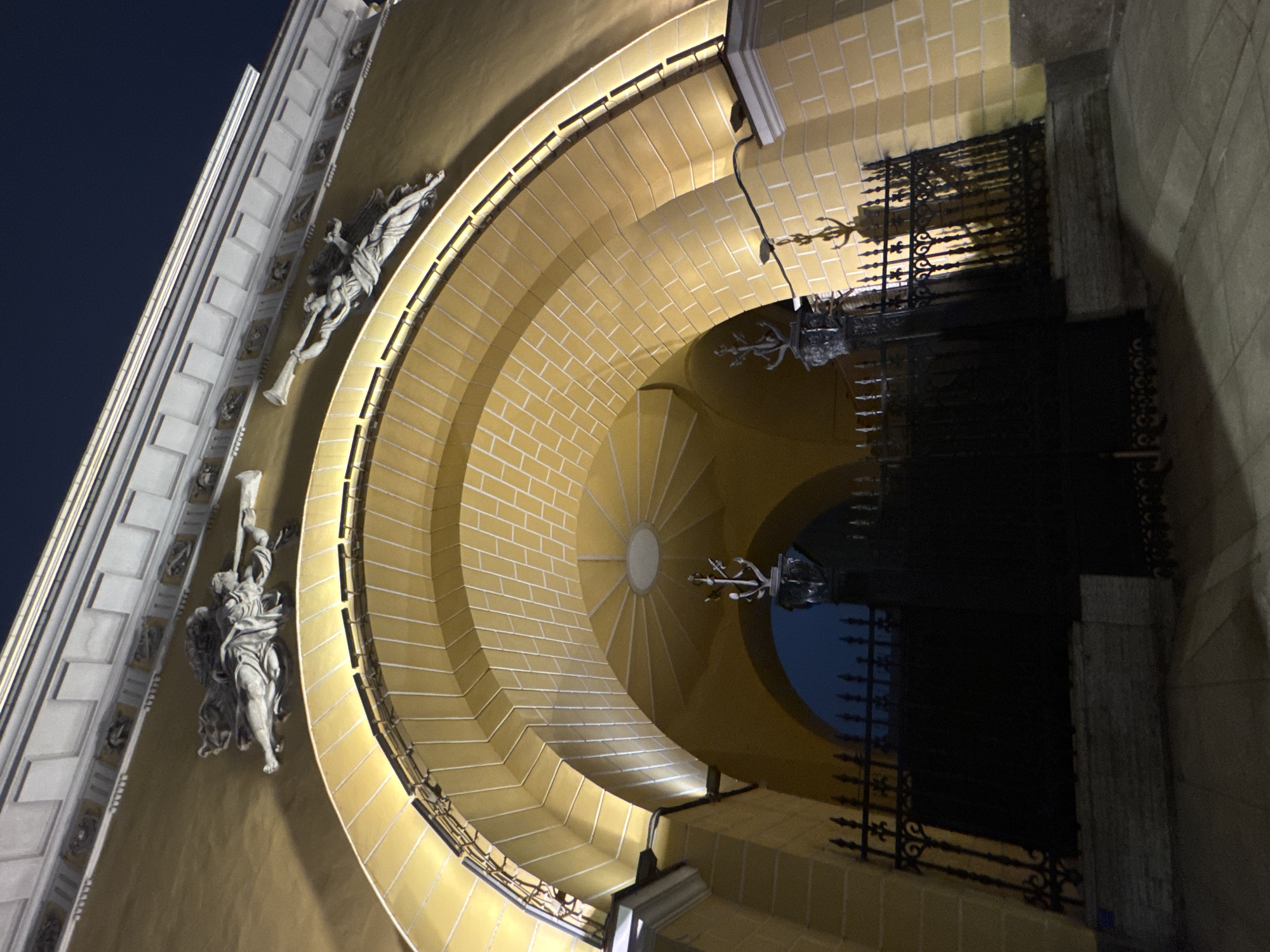 Evening life captured around illuminated historic Saint Petersburg buildings