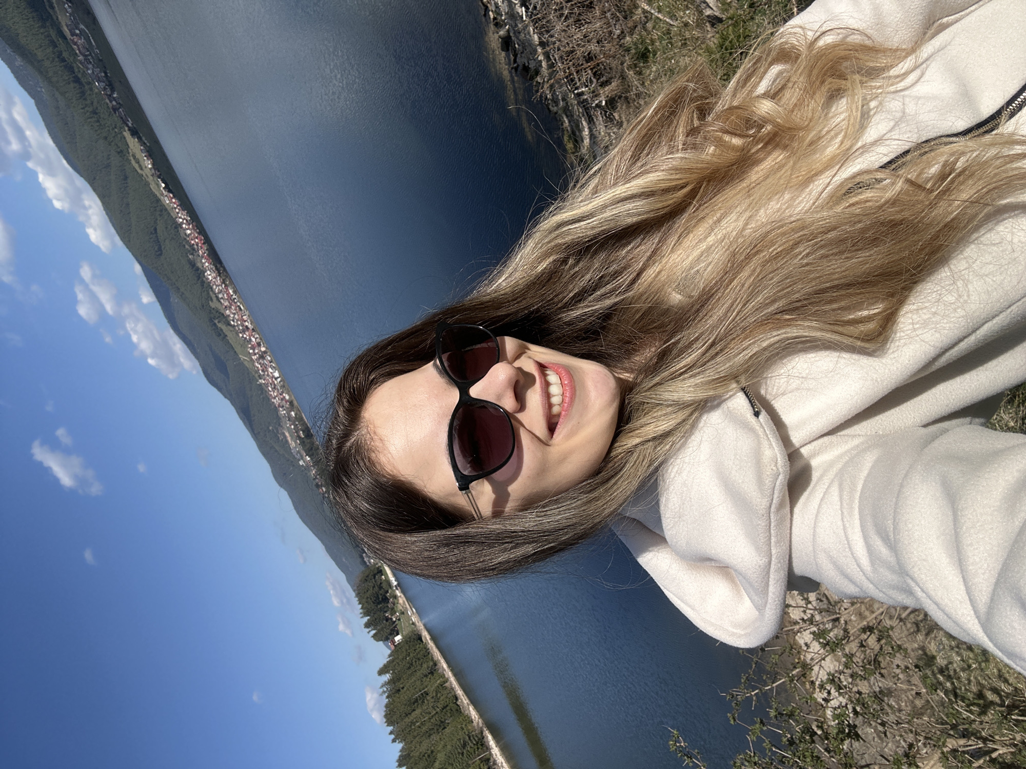 Woman poses for photos at Lake Dospat, Bulgaria