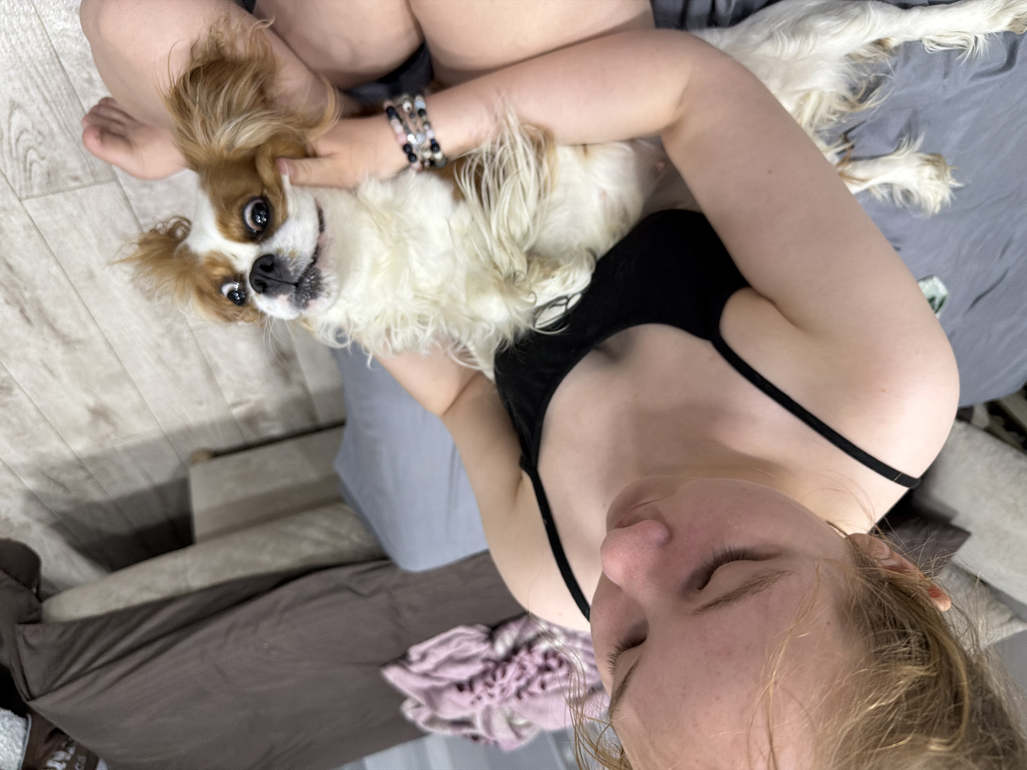 Woman poses with Cavalier King Charles Spaniel in Chaikovsky