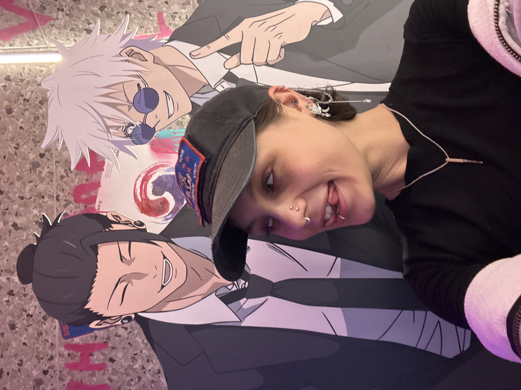 Person poses with anime character displays in Moscow interior