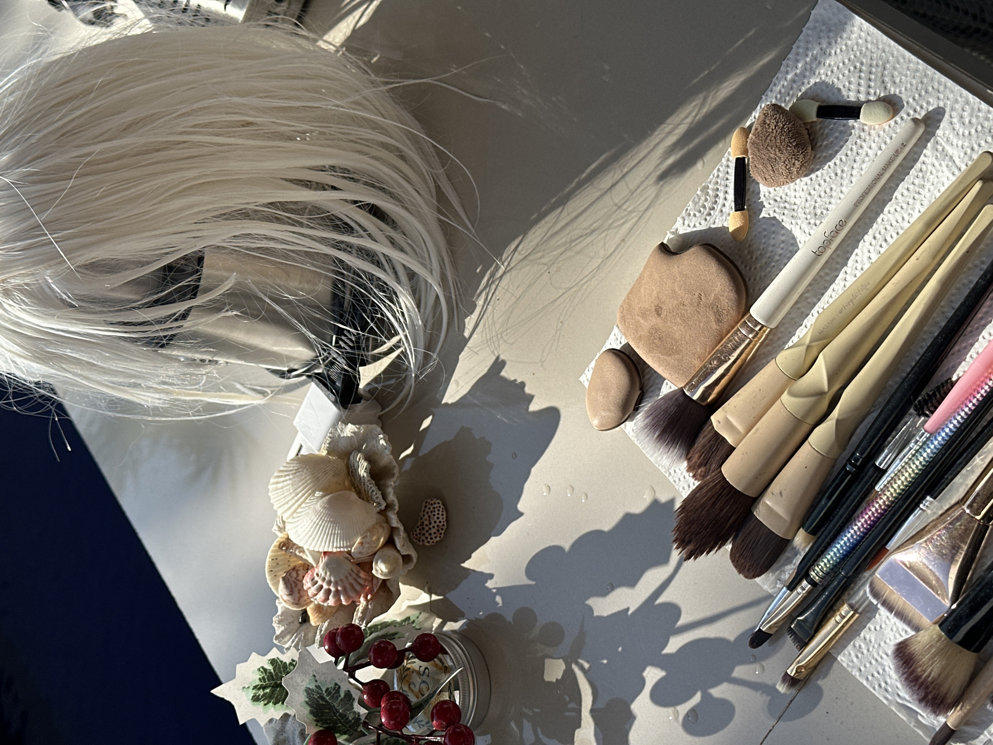 Makeup tools and a blonde wig laid out in North Kuta