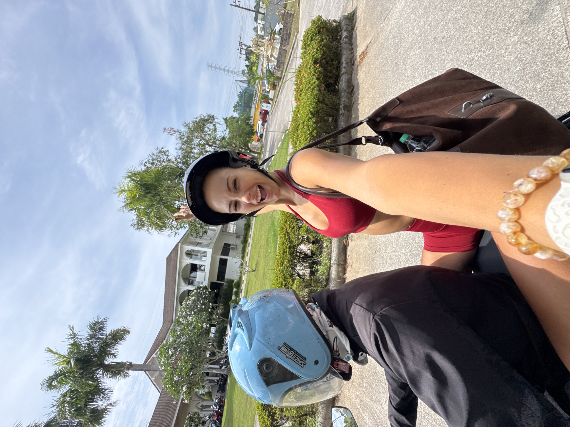 Person in anime shirt sits outdoors in Kathu, Thailand