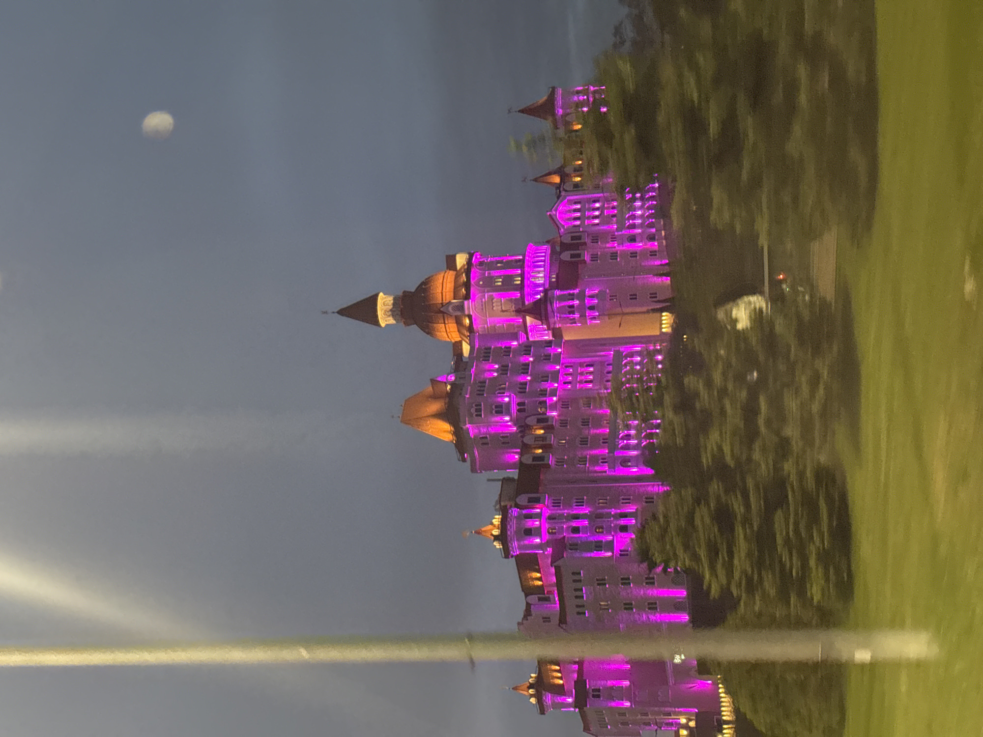 Bogatyr Castle Hotel illuminated in purple lights, Sirius Russia