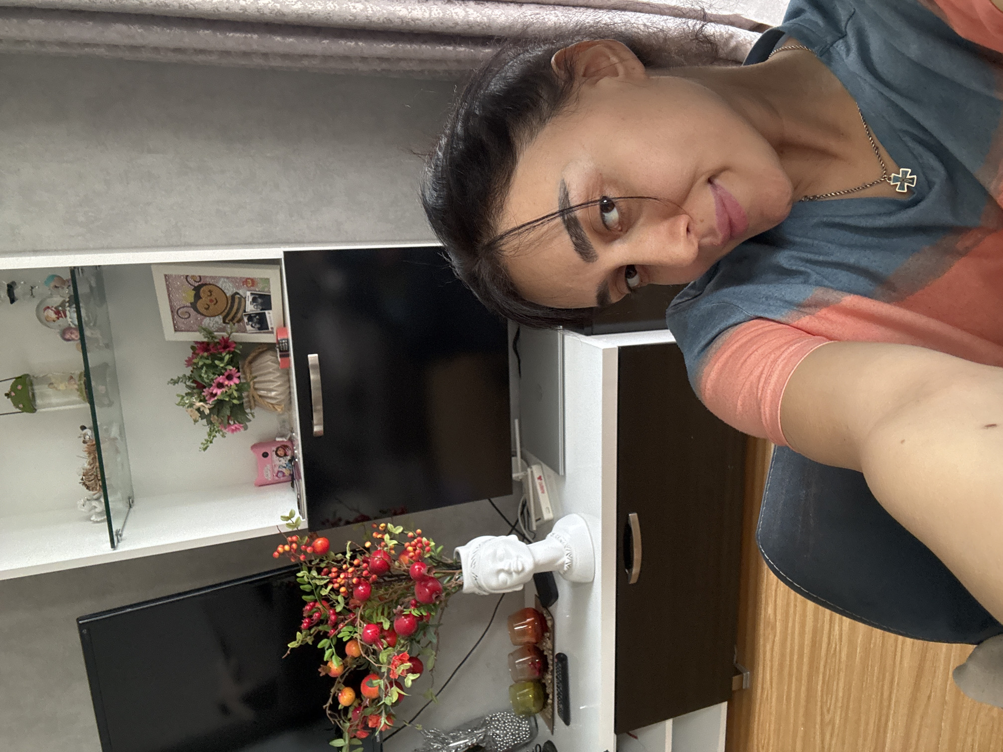 Woman takes indoor selfies near window in Tbilisi