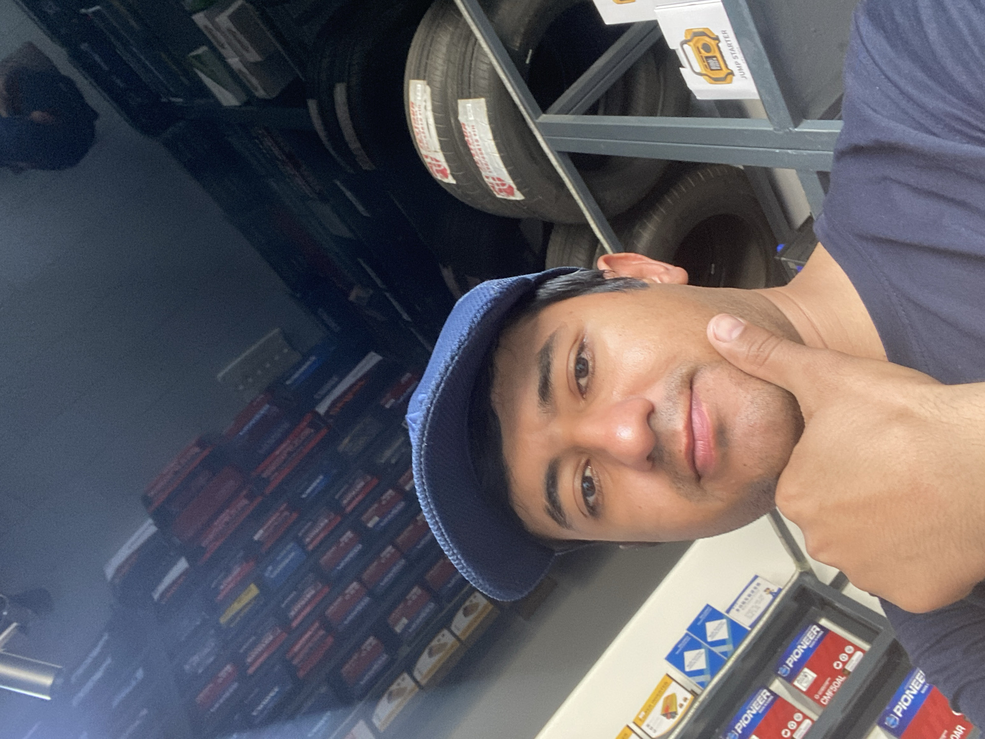 Man takes selfies in Bukhara automotive parts store
