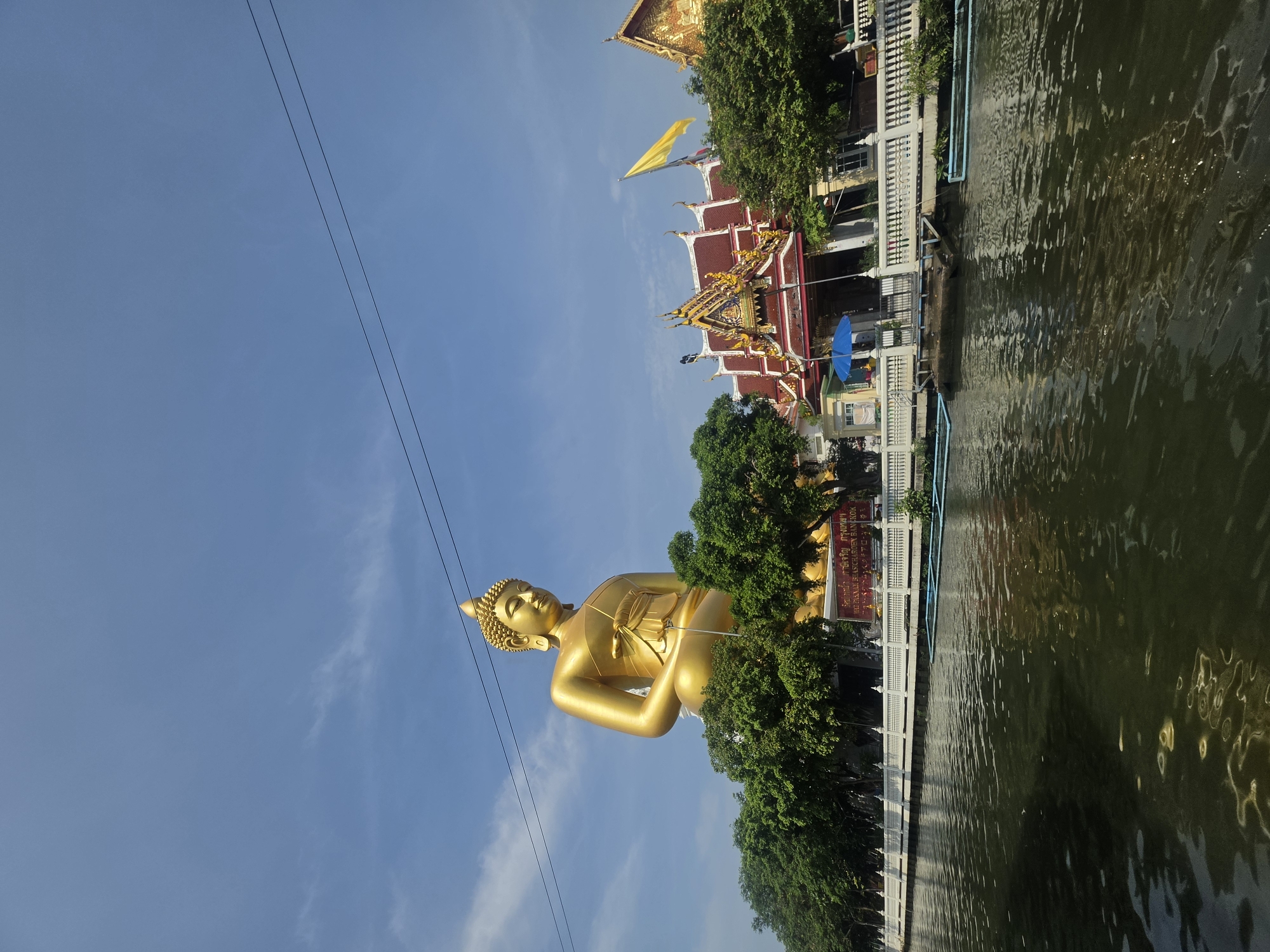 Early morning longtail boat activity near Bangkok temple district
