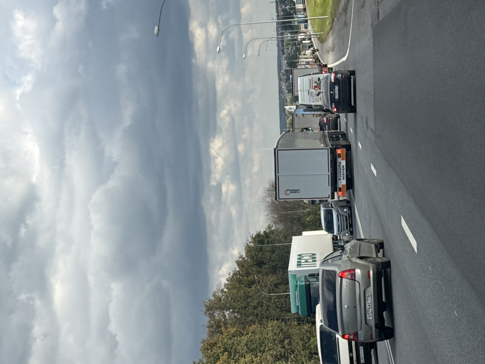 Heavy highway traffic backs up under dark, cloudy skies