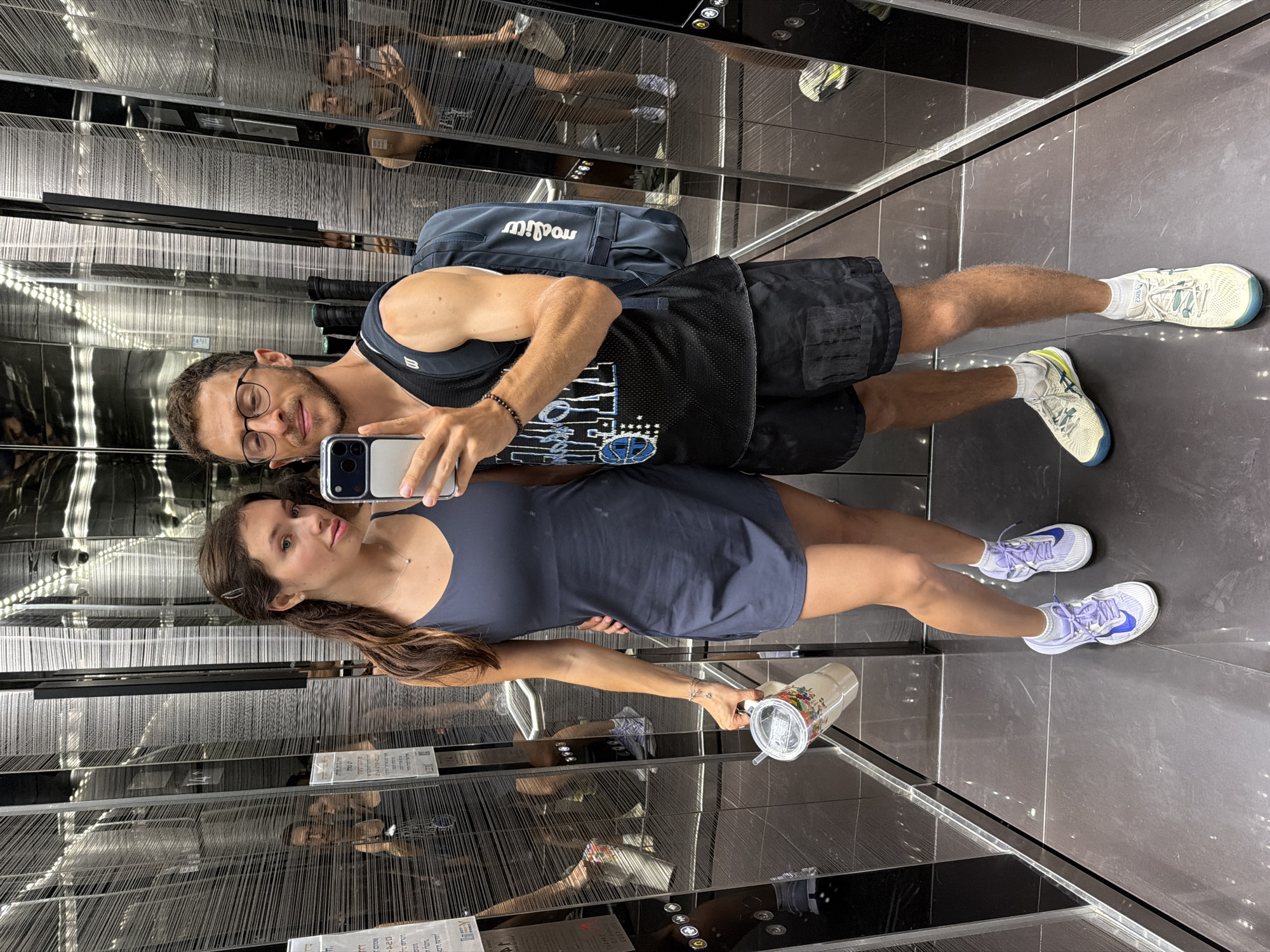 Couple Takes Selfie in Modern Mirrored Elevator