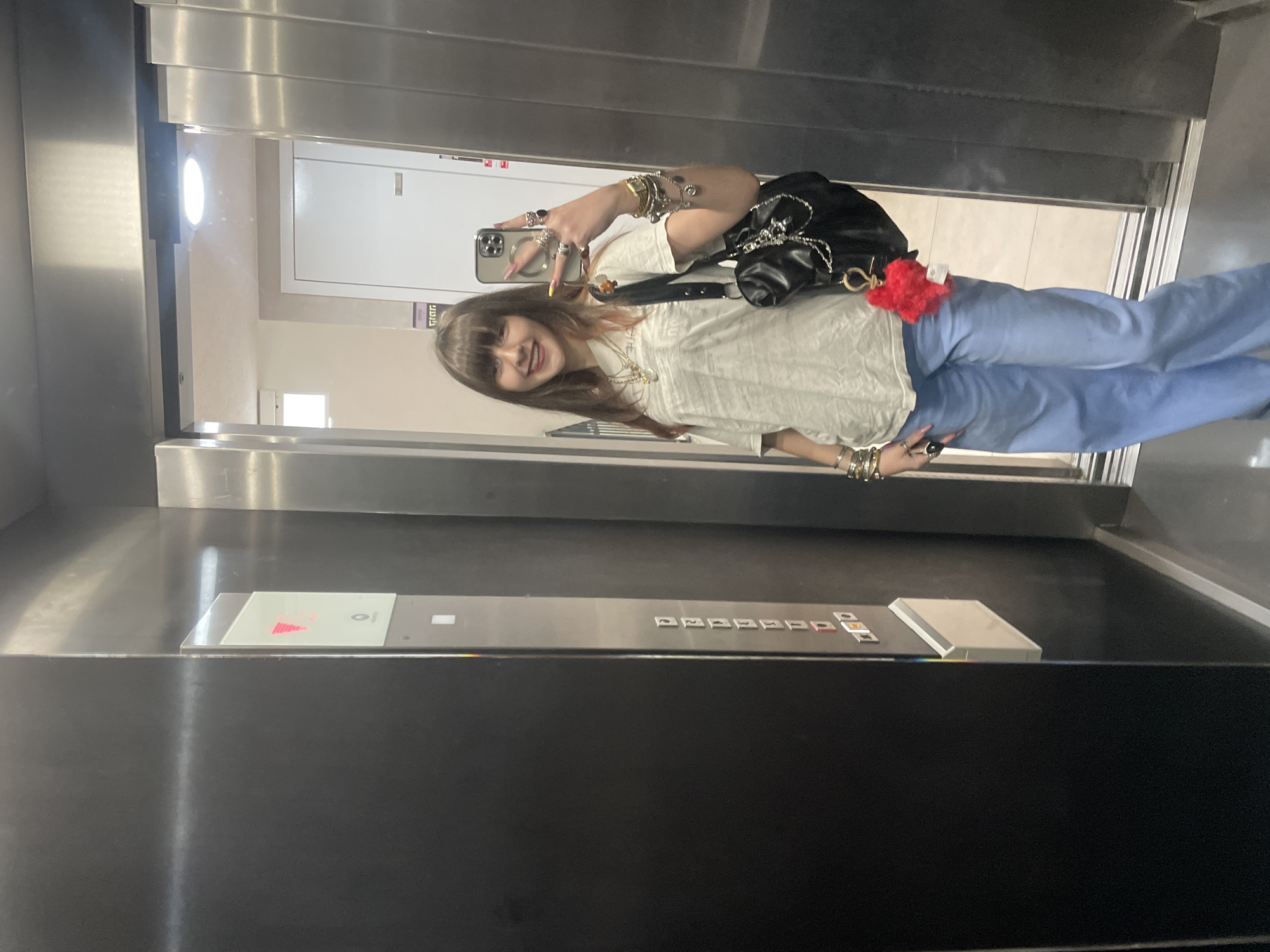Woman takes selfies in elevator and outdoors in Raanana