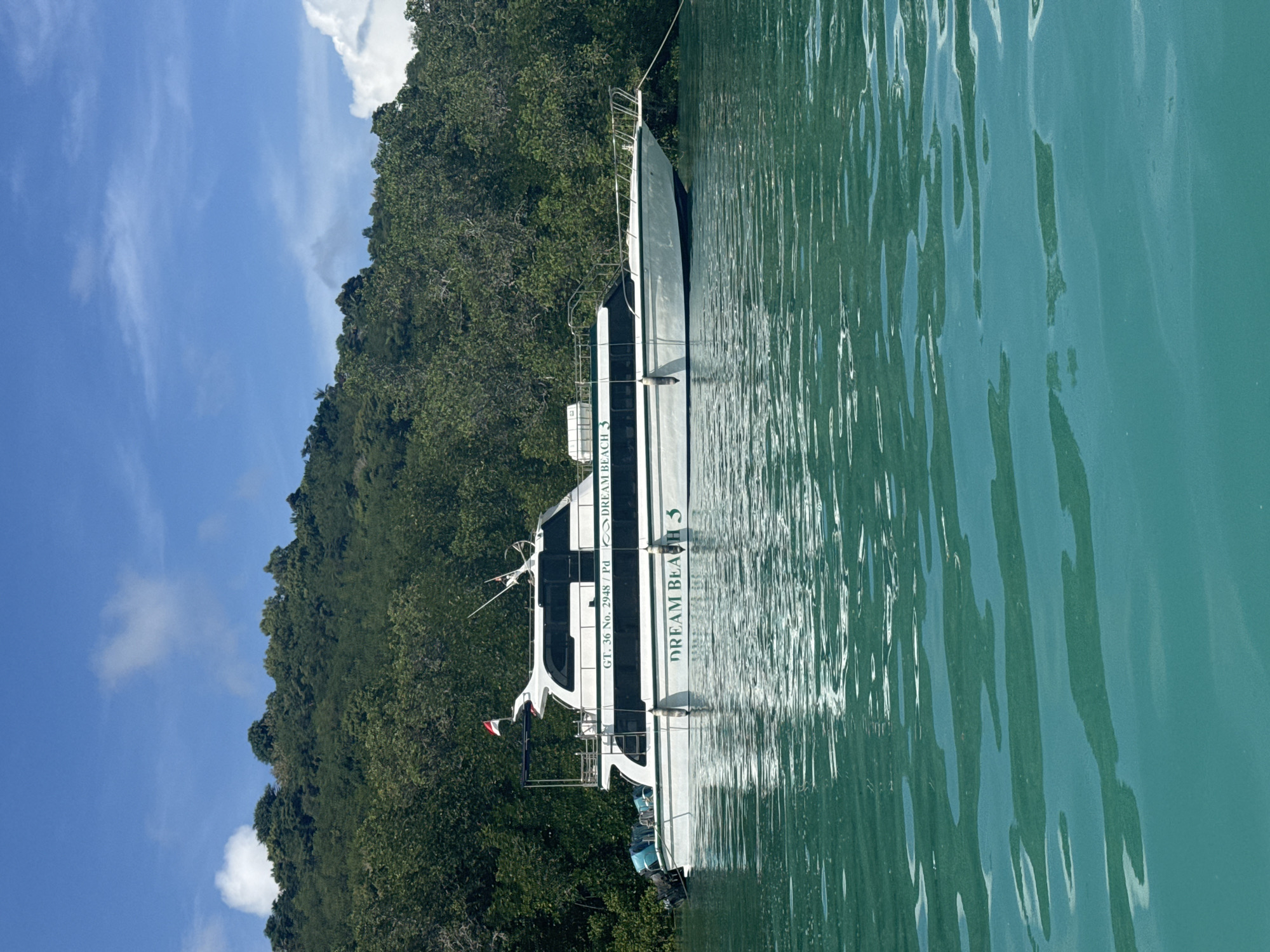 Boats navigate turquoise waters near Nusa Penida coastline