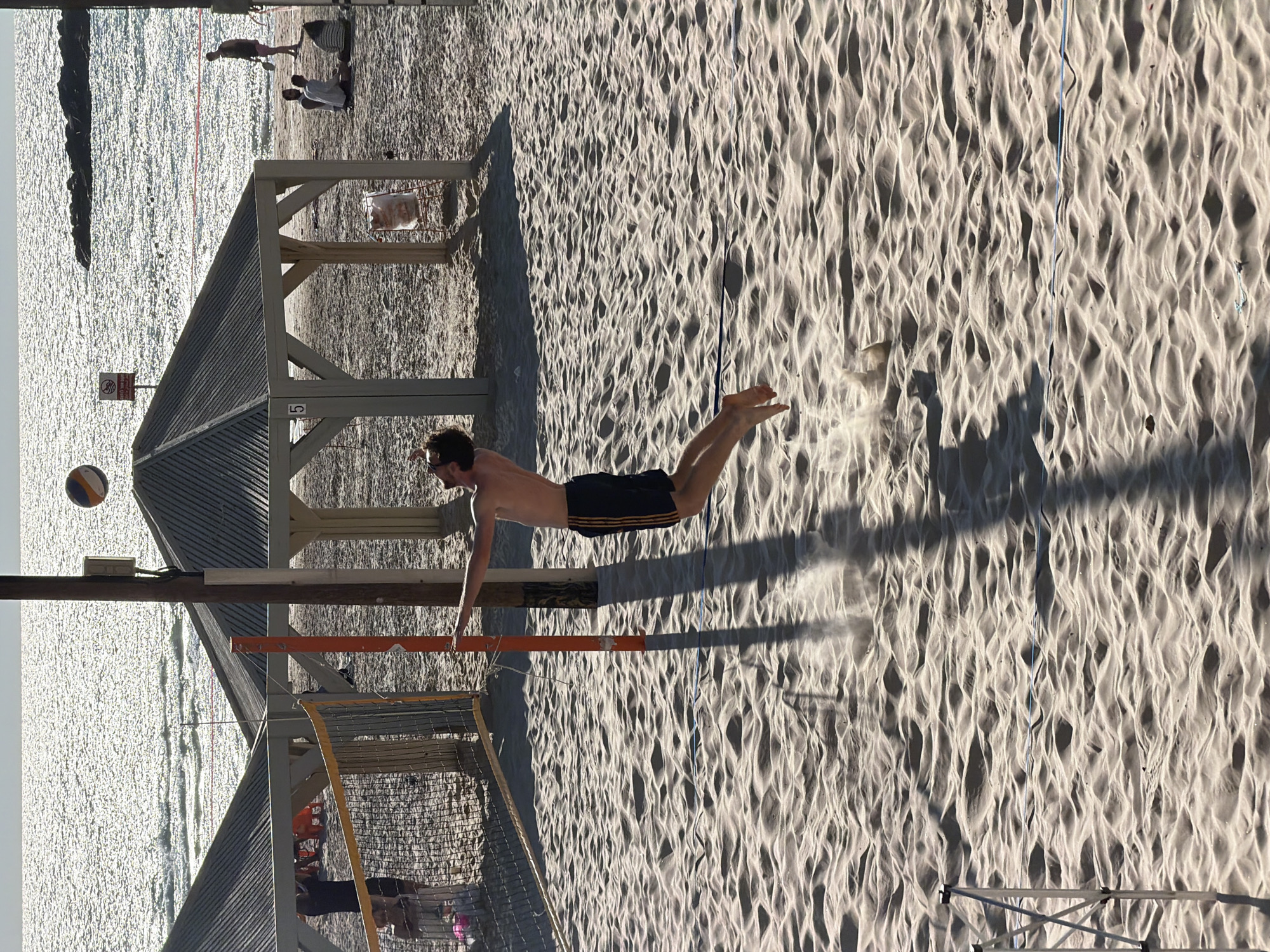 Tel Aviv beachgoers enjoy volleyball, kites amid sunny skies