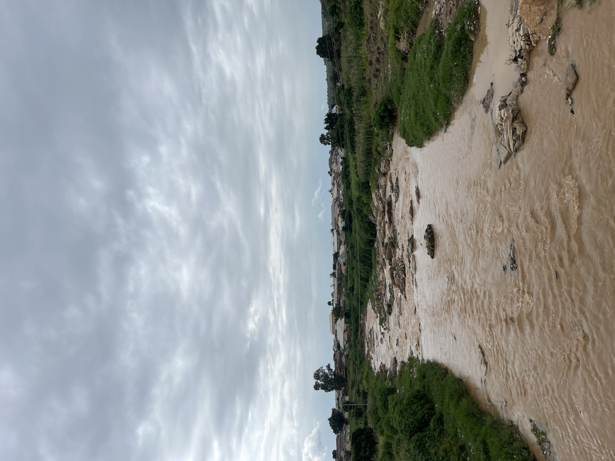 Group crosses bridge over polluted river in Rafin Par, Nigeria