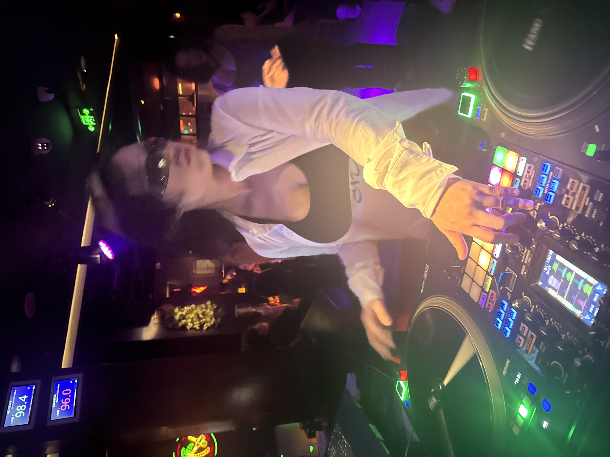 DJ works a Pioneer console at a Liangjiang nightclub