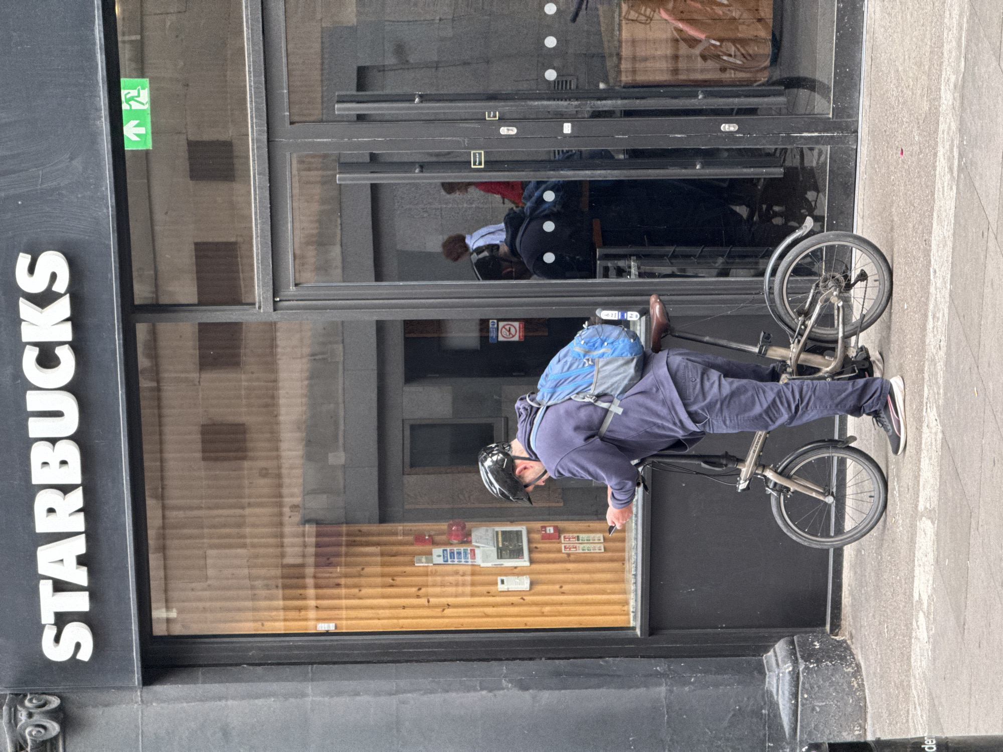 Quick phone check mid-ride with a folding bike in London