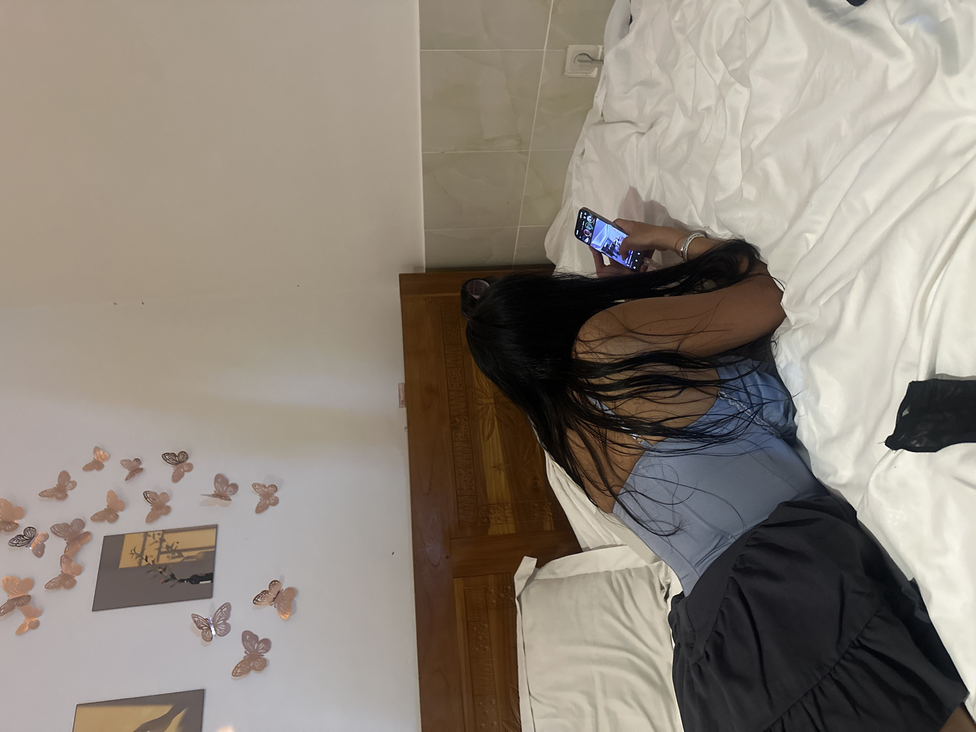 Indoor moments captured in North Kuta: phone use, mirror scene