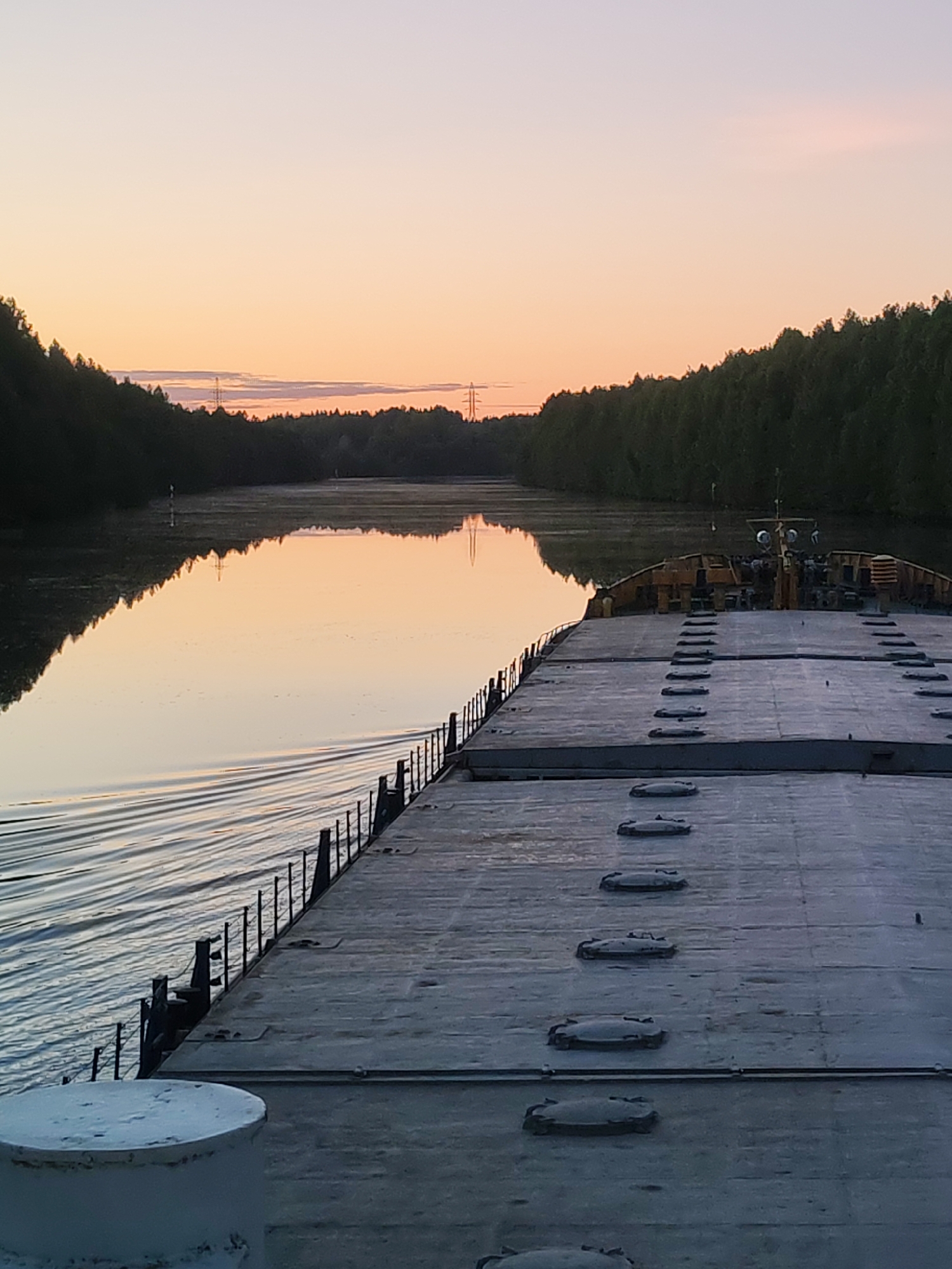 Peaceful sunrise captured from vessel deck near Devyatiny, Russia