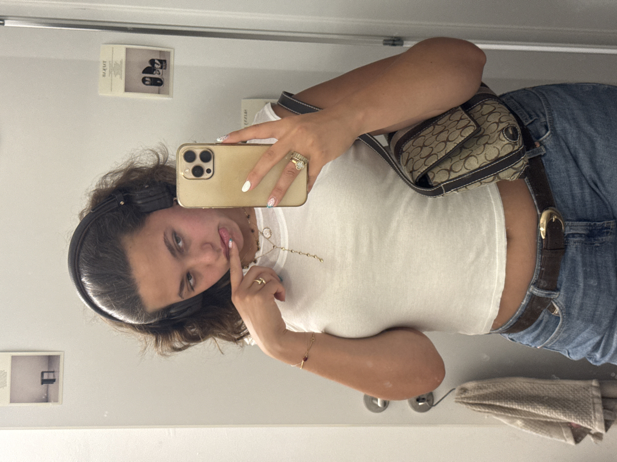 Mirror selfie session in a Milan fitting room, July 2026