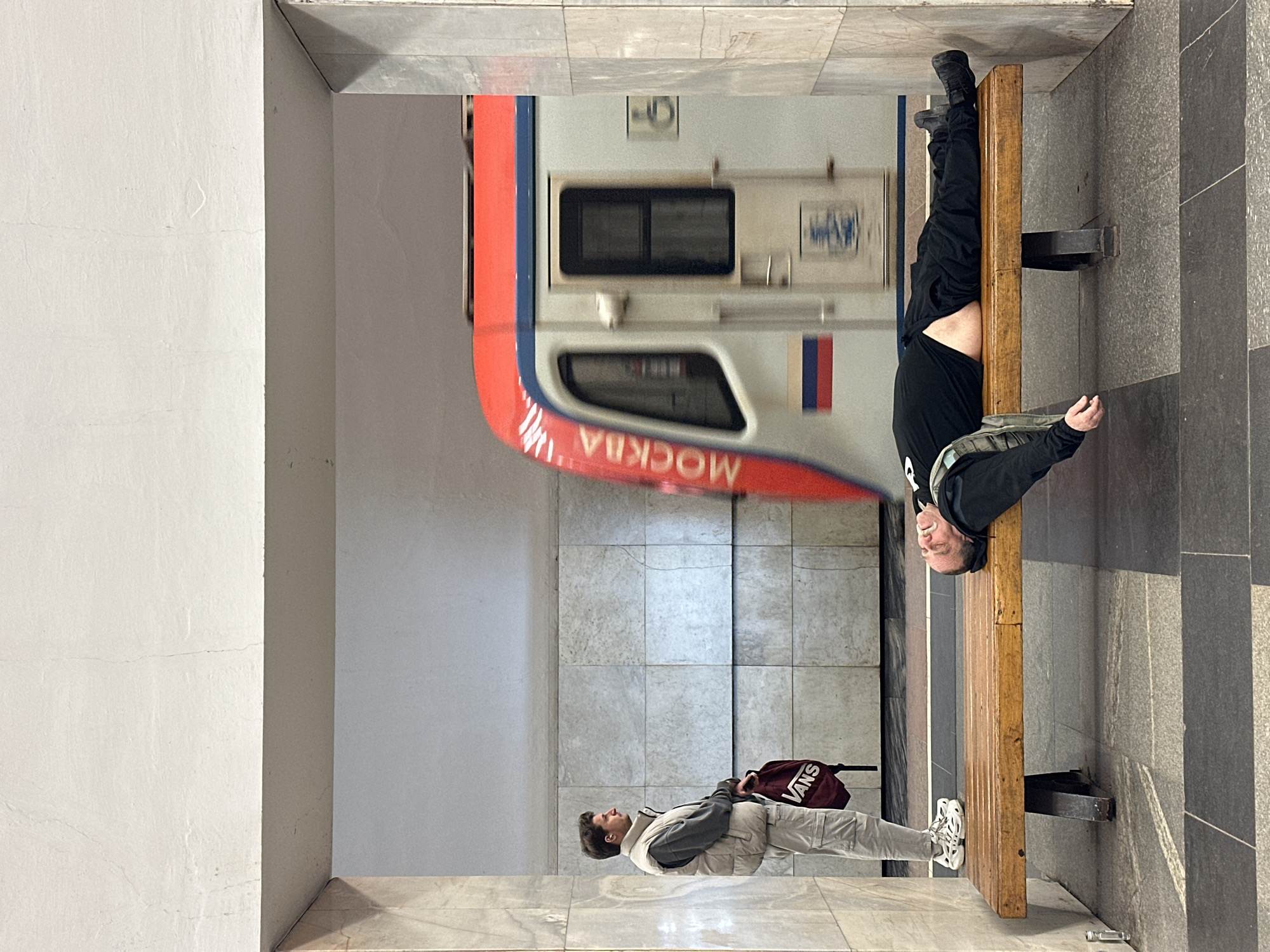 Person resting on bench at Moscow metro station