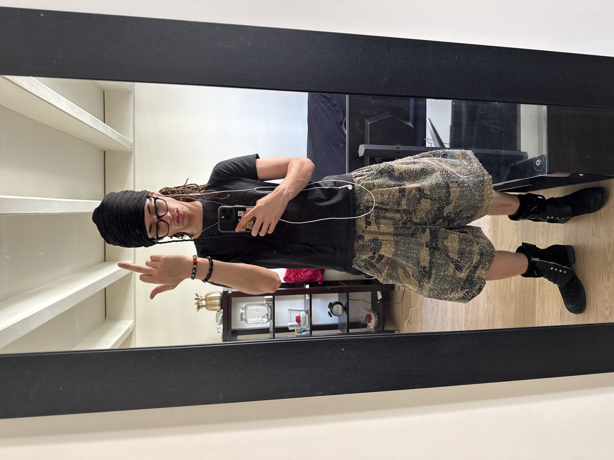Person takes mirror selfie in distinctive outfit in Paris