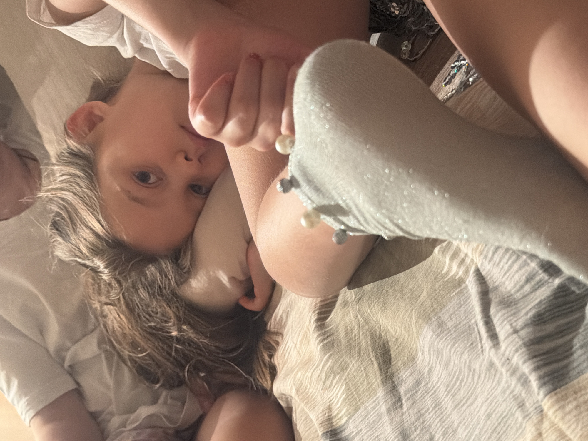 Children rest on bedspread in Krasnoyarsk home