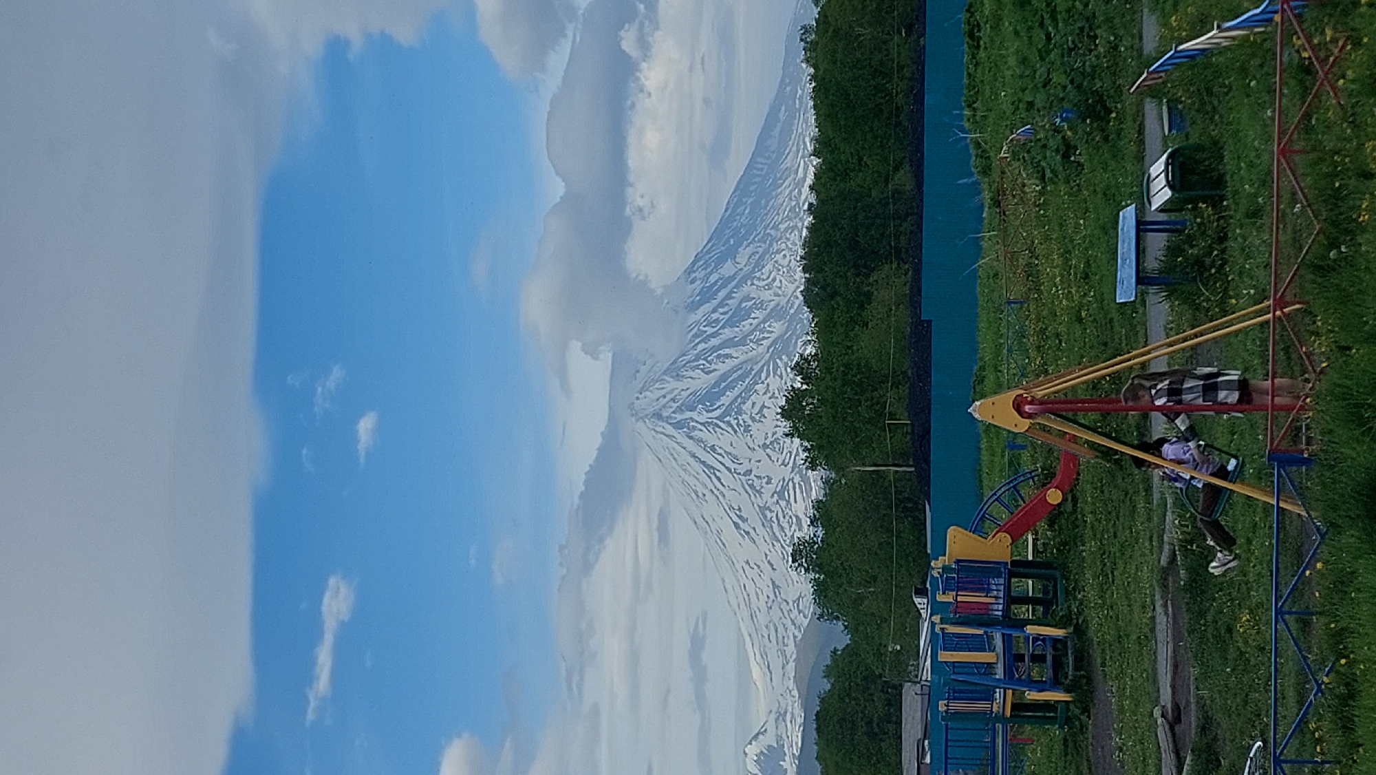 Neighborhood playground backed by volcanoes, Зелёный, Russia