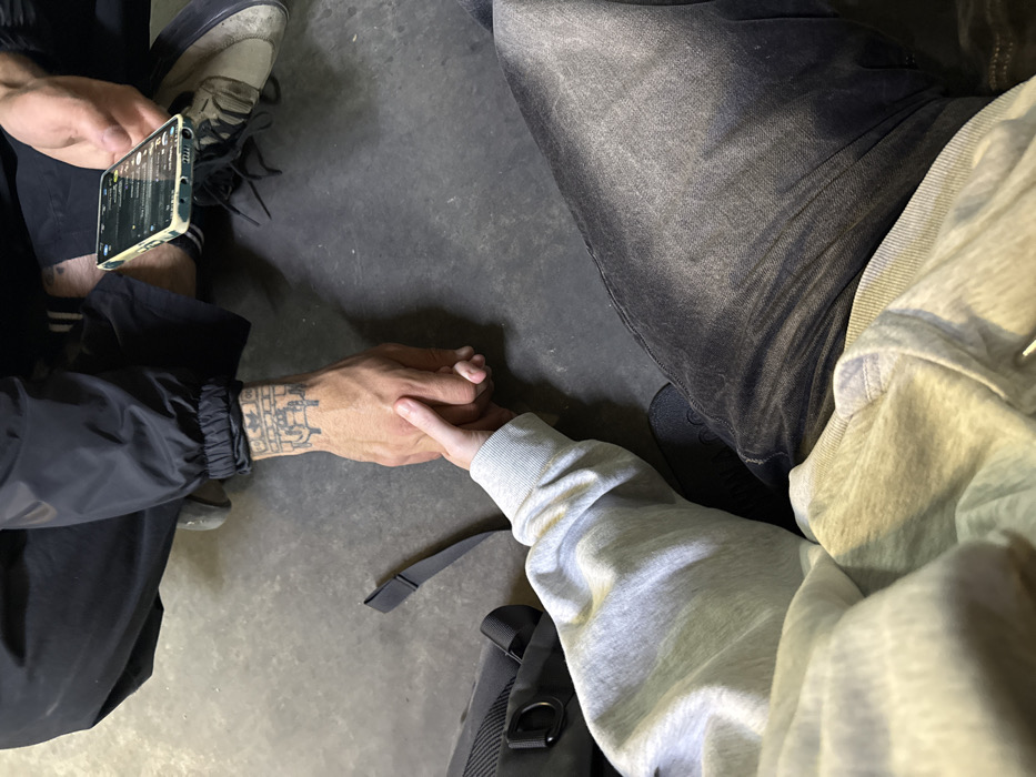Two people seated on floor in Ramat Gan
