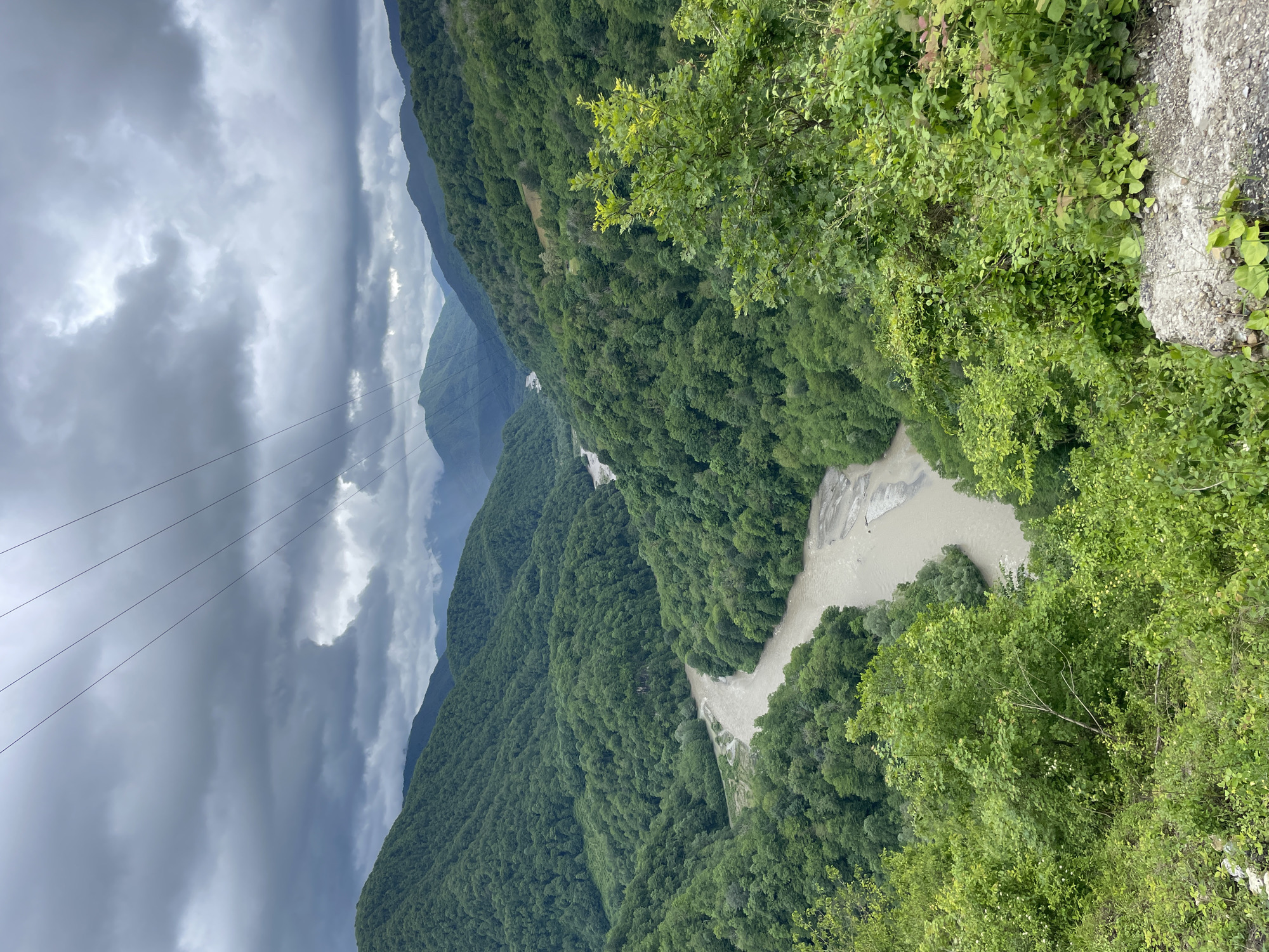 Tourist documents mountain adventure at Russian scenic viewpoint