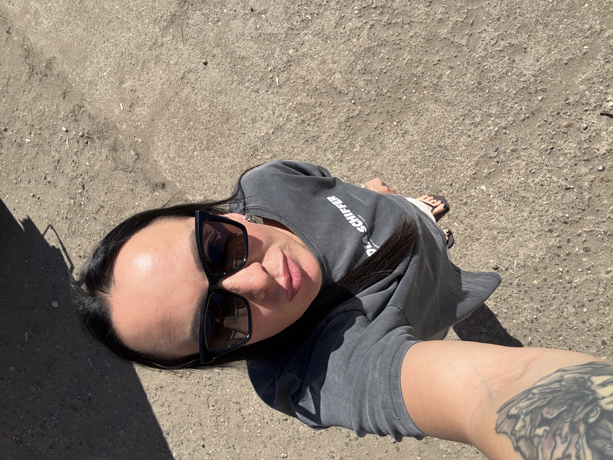 Woman takes selfie on dirt surface in Chaikovsky, Russia