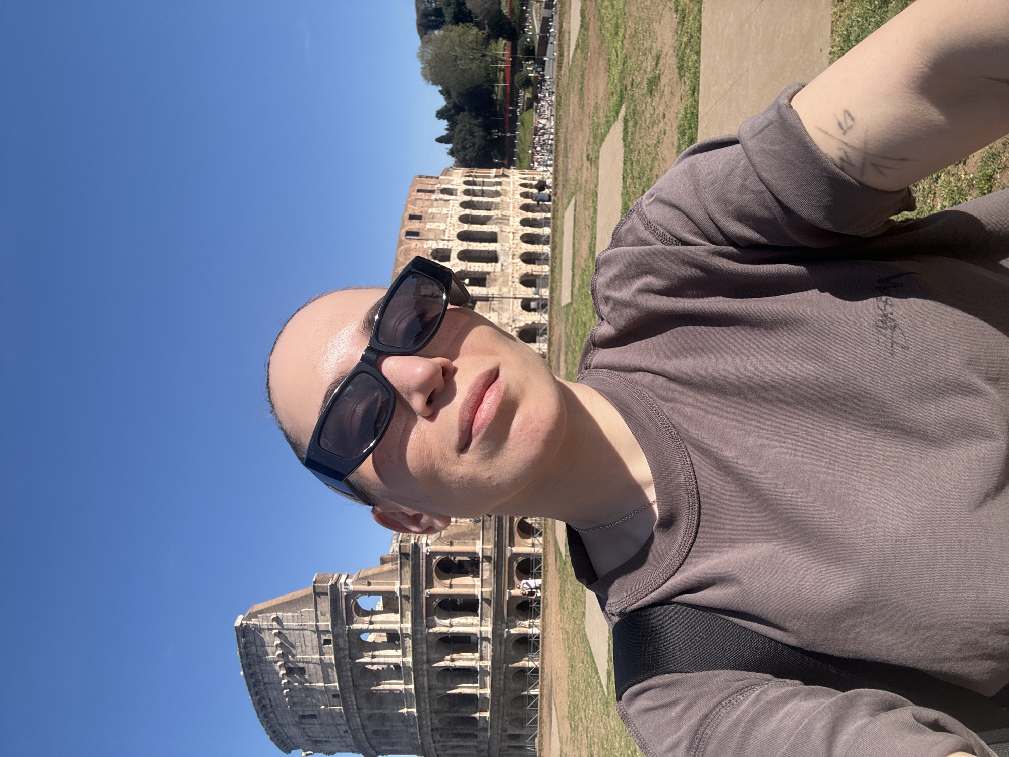 Tourist photographs and rests at Rome's Colosseum