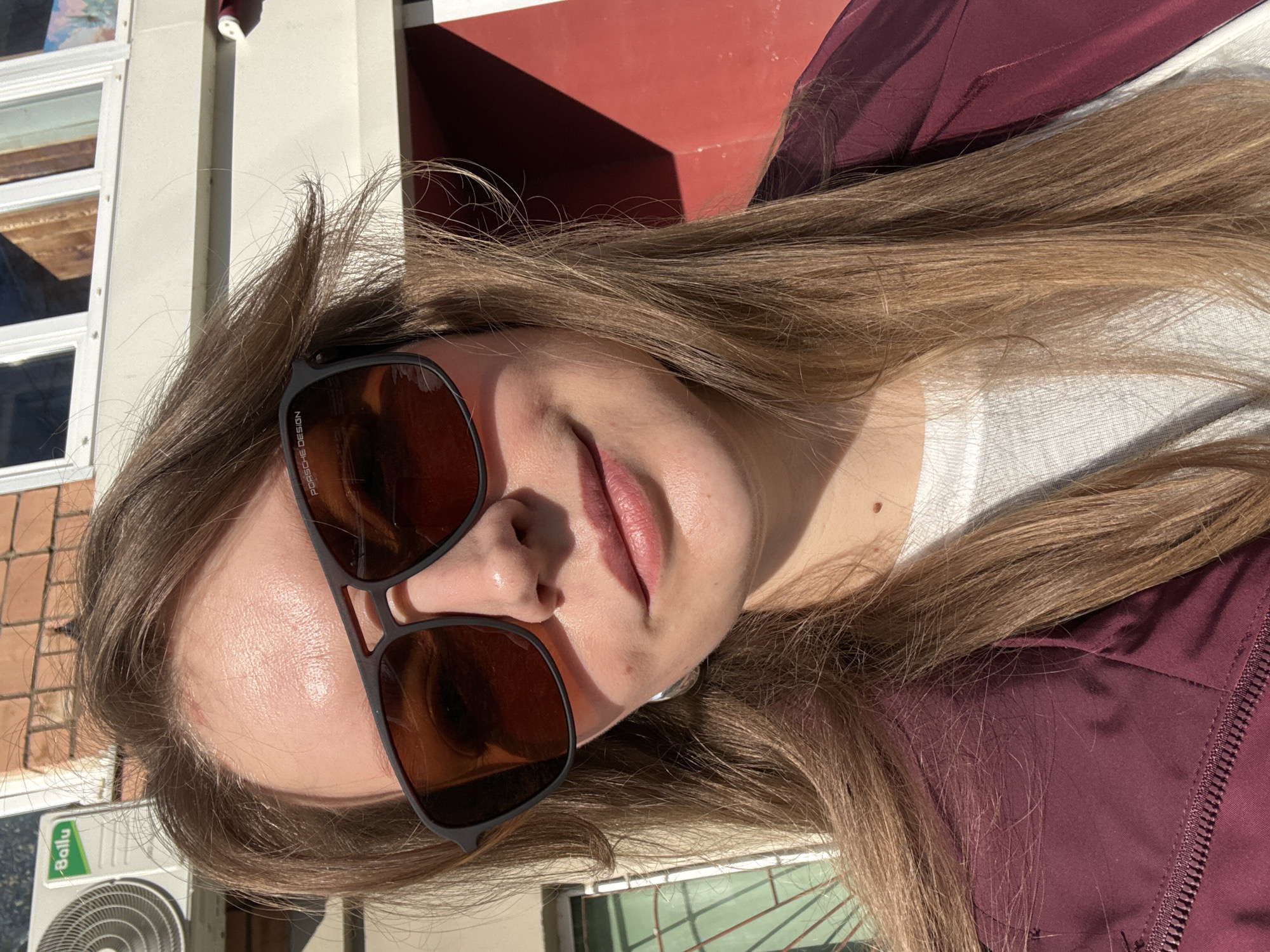 Woman in burgundy jacket photographed outdoors in Izhevsk