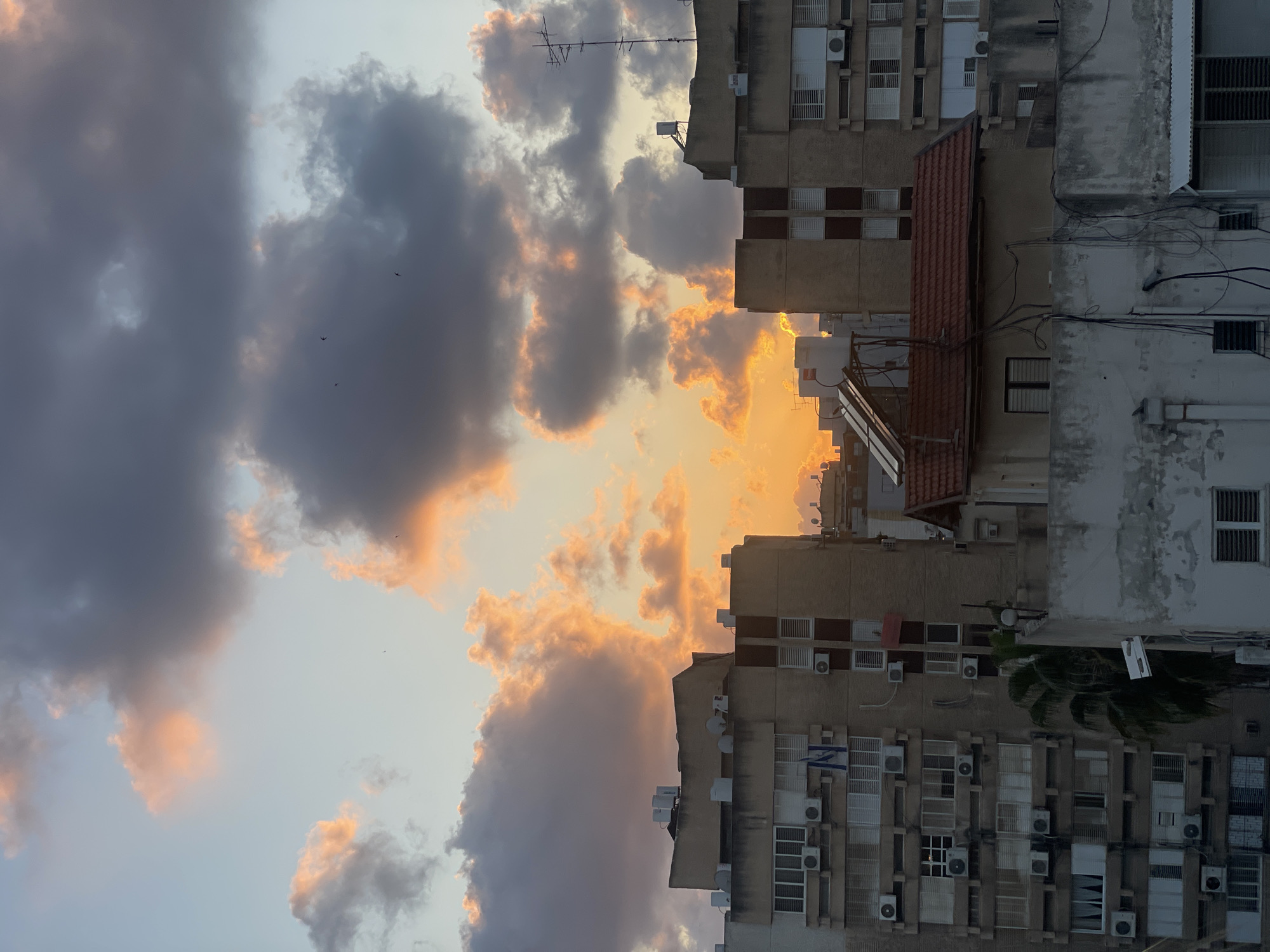 Sunset captured over Petah Tikva buildings amid evening observations