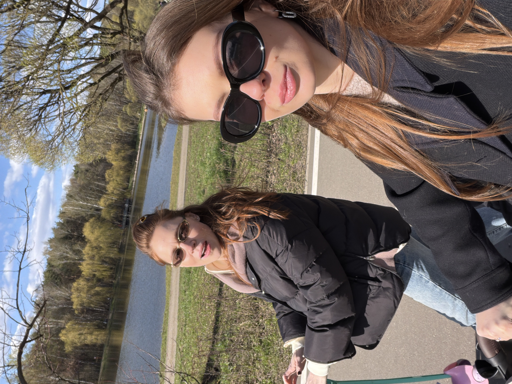 Women pose for photos in Moscow park during spring day